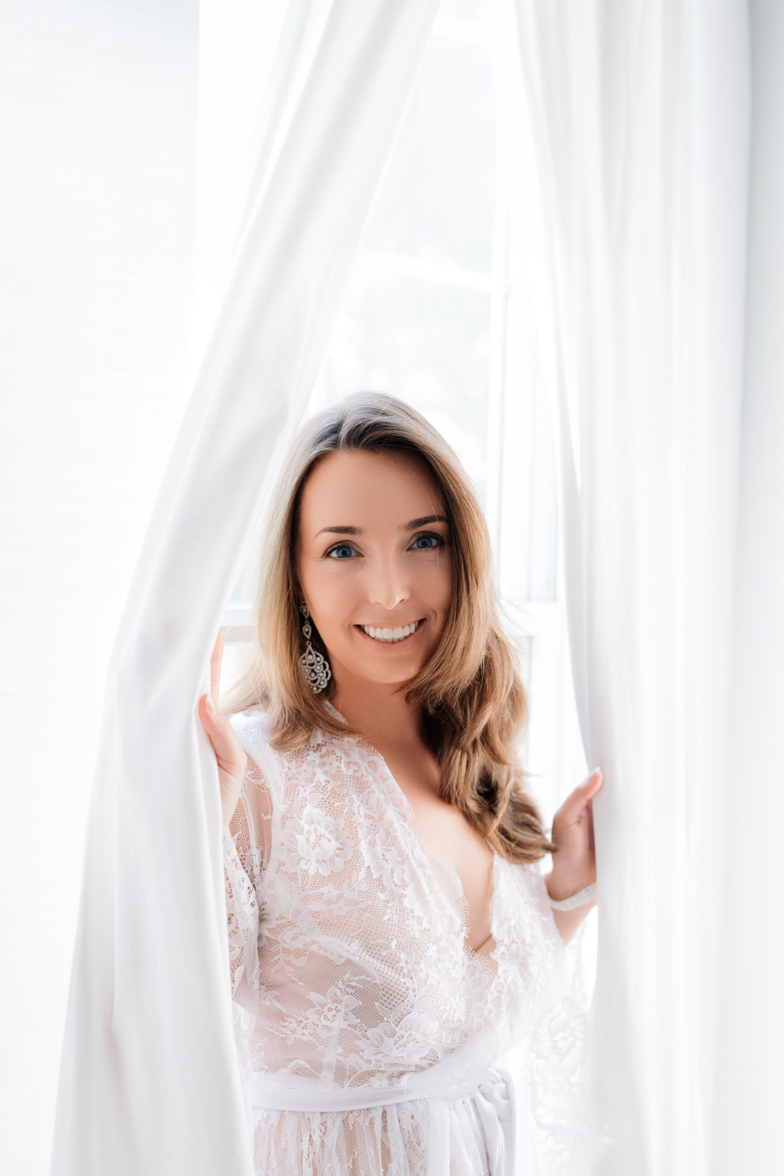 a woman in a white dress is posing