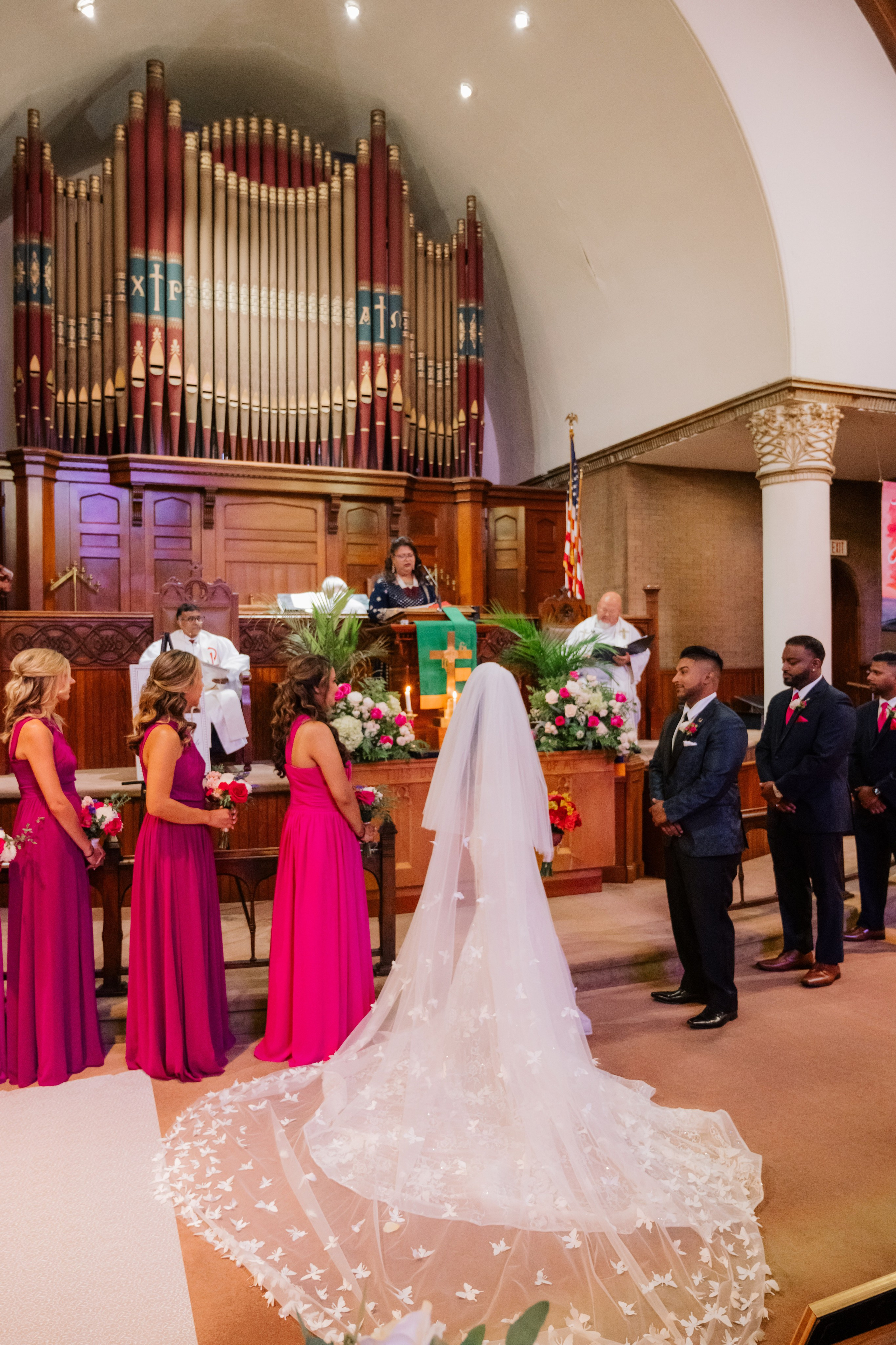 a bride and groom are standing in front of the altar
