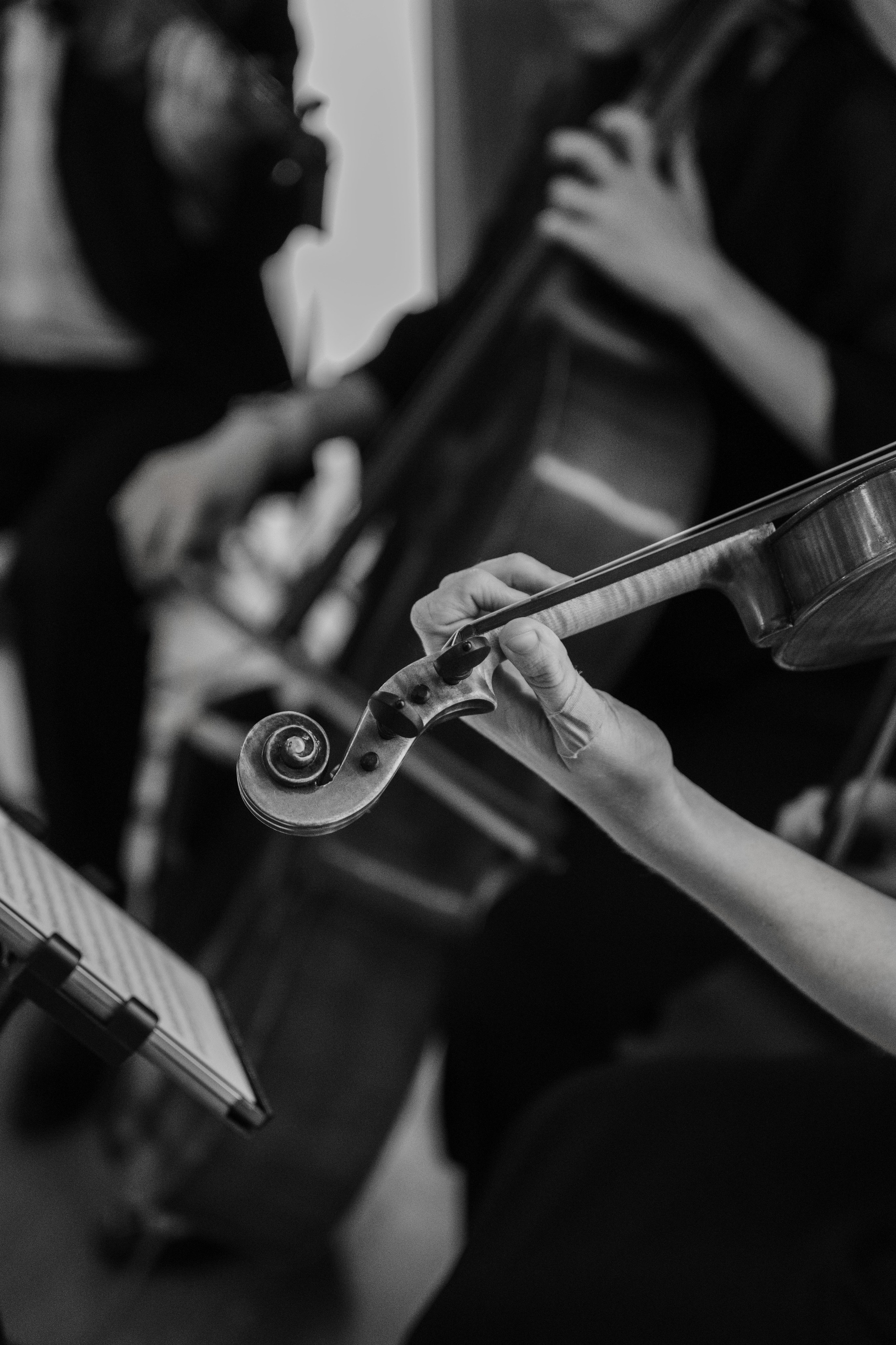 a woman playing a violin in a room