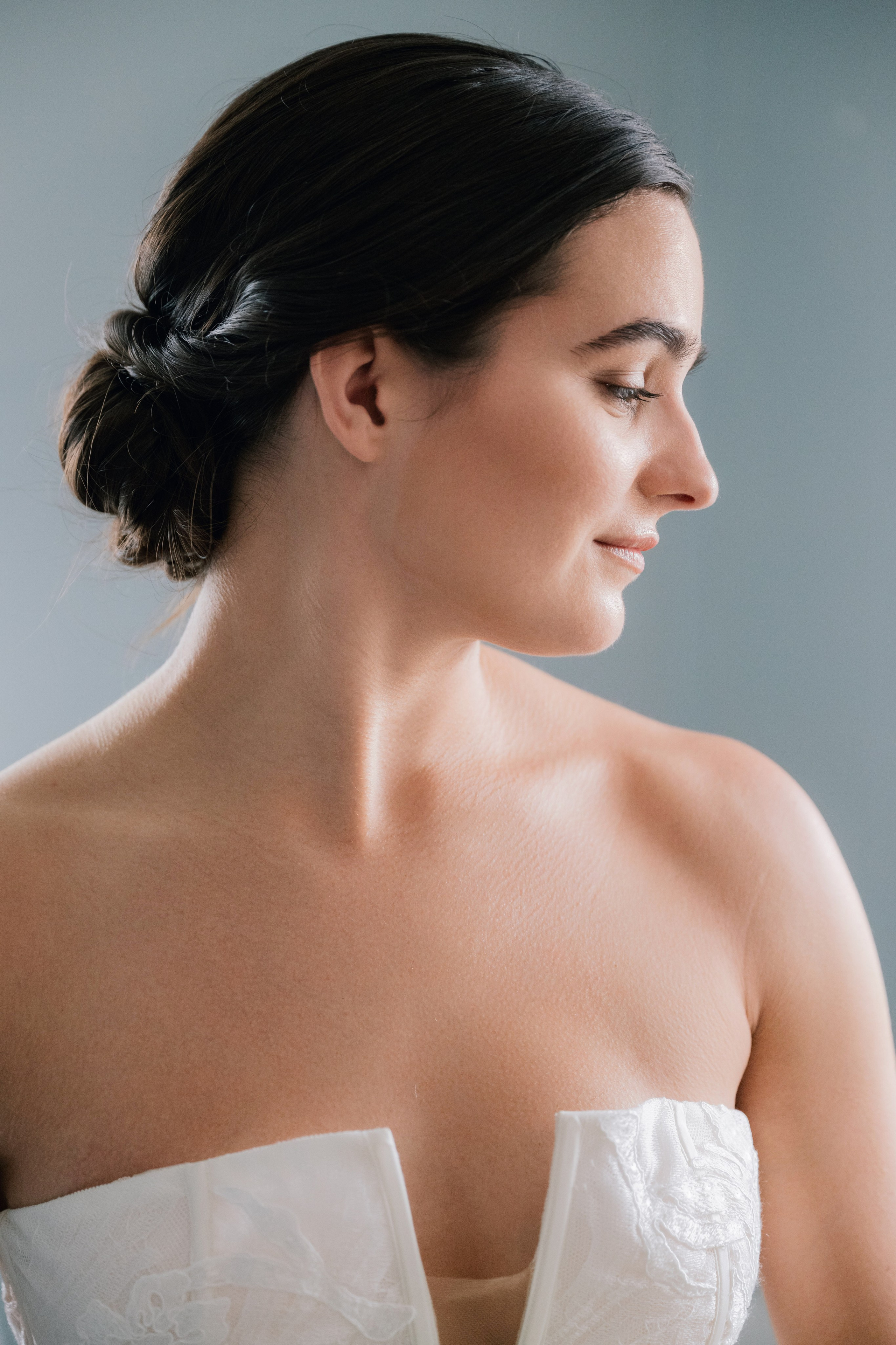 a woman in a wedding dress looking down