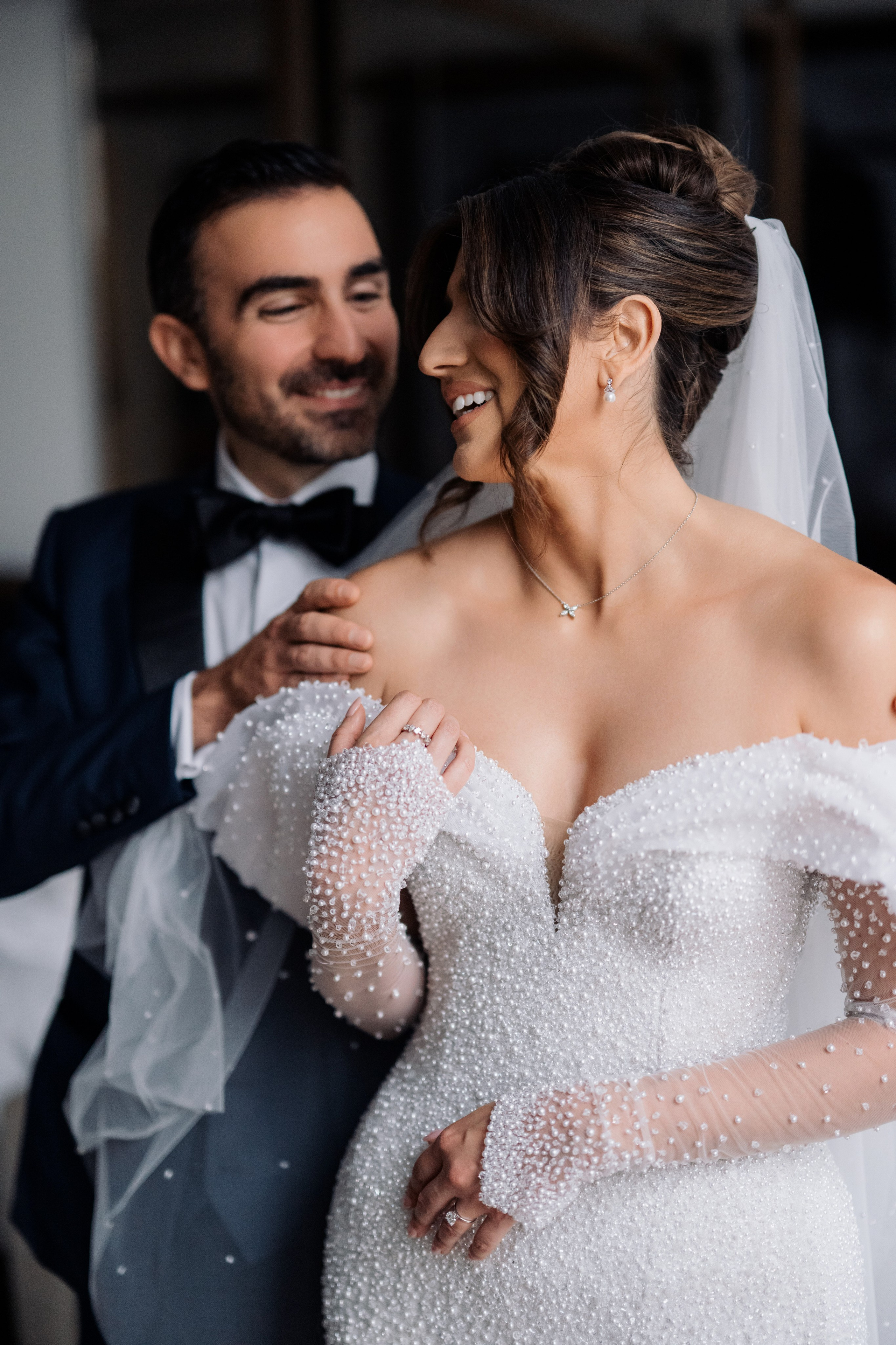 a bride and groom pose for a photo