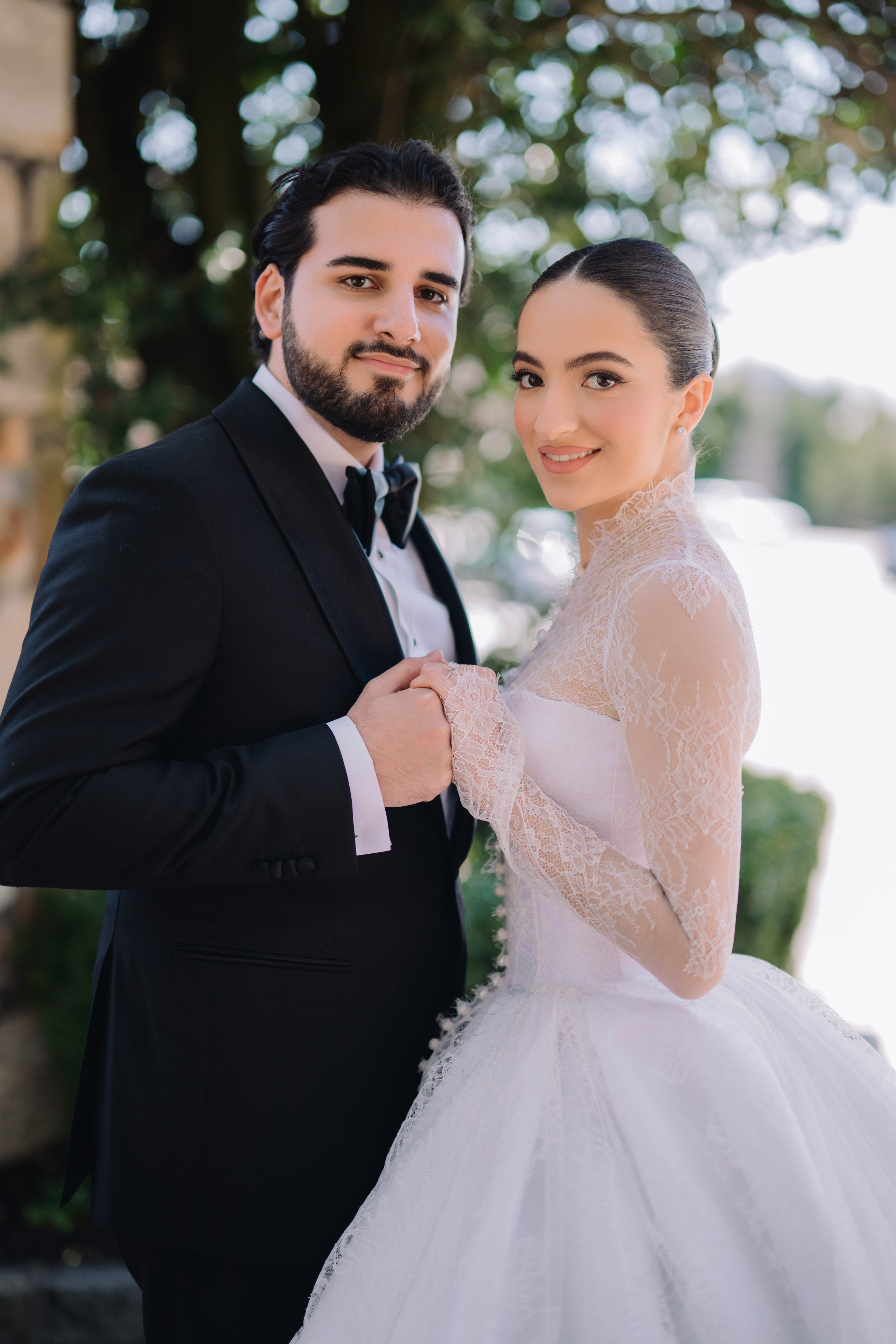 a bride and groom pose for a photo