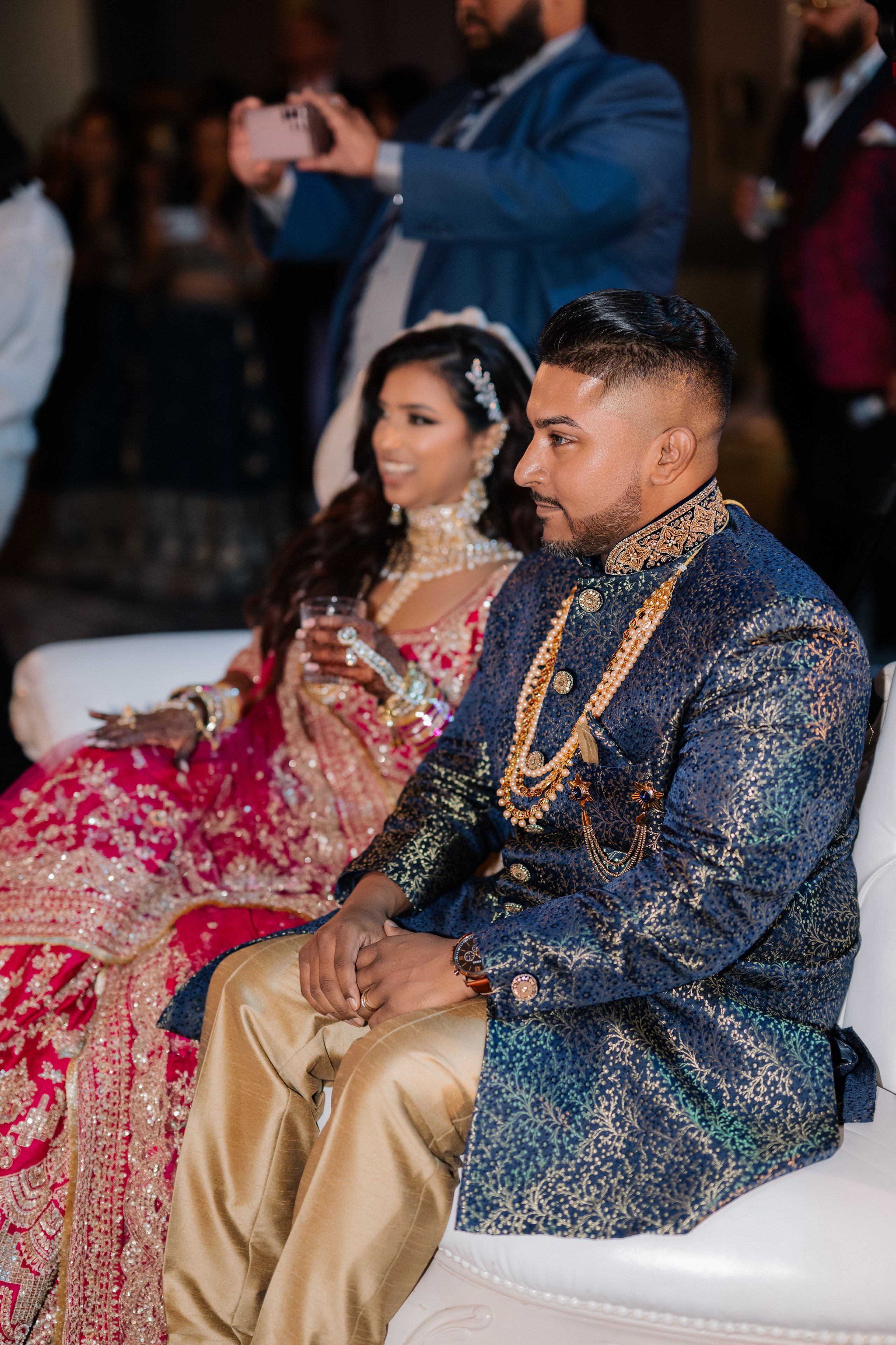 a man and woman sitting on a white chair
