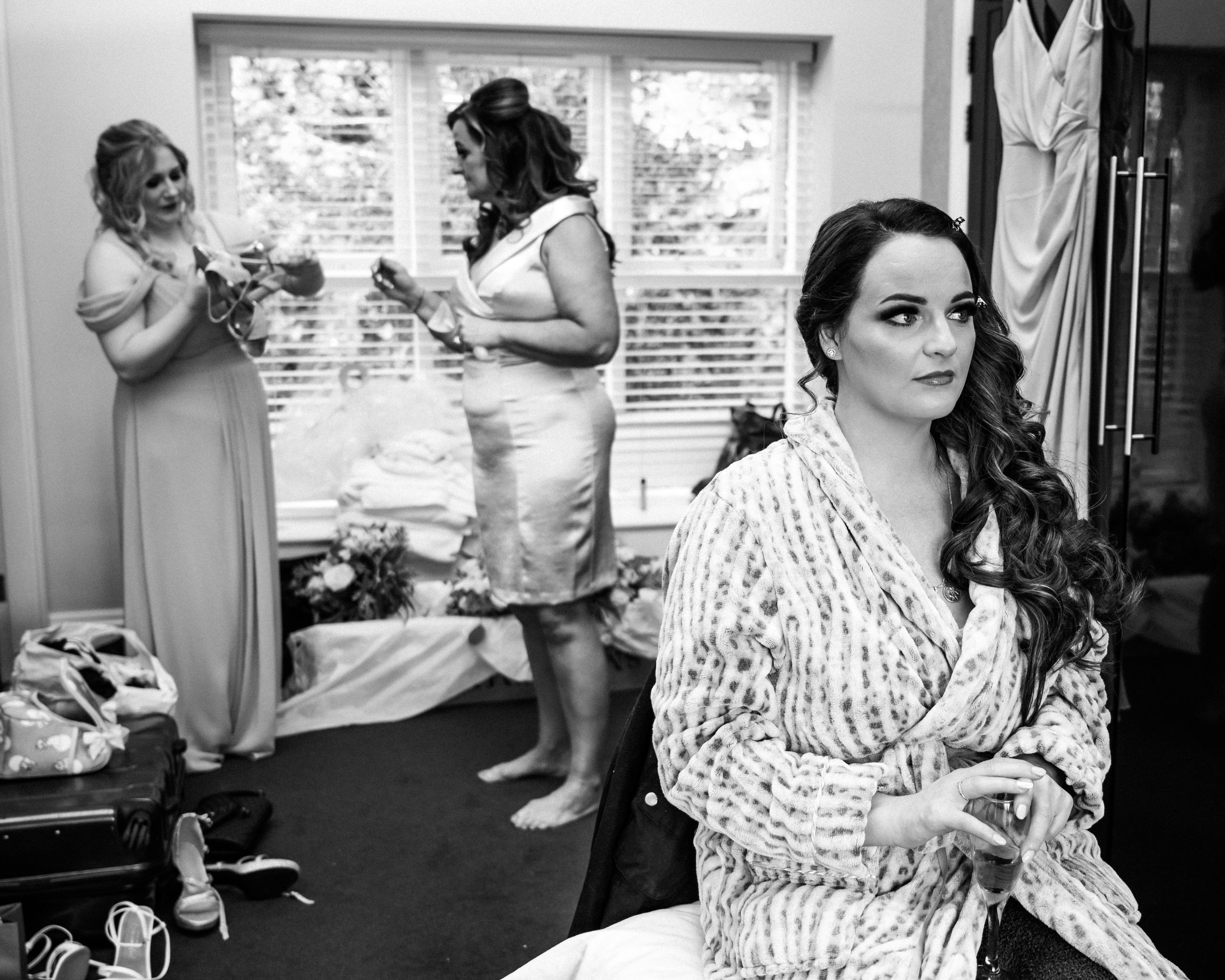 The bride and groom stand at the entrance of Aston Hall, looking blissful and elegant.
