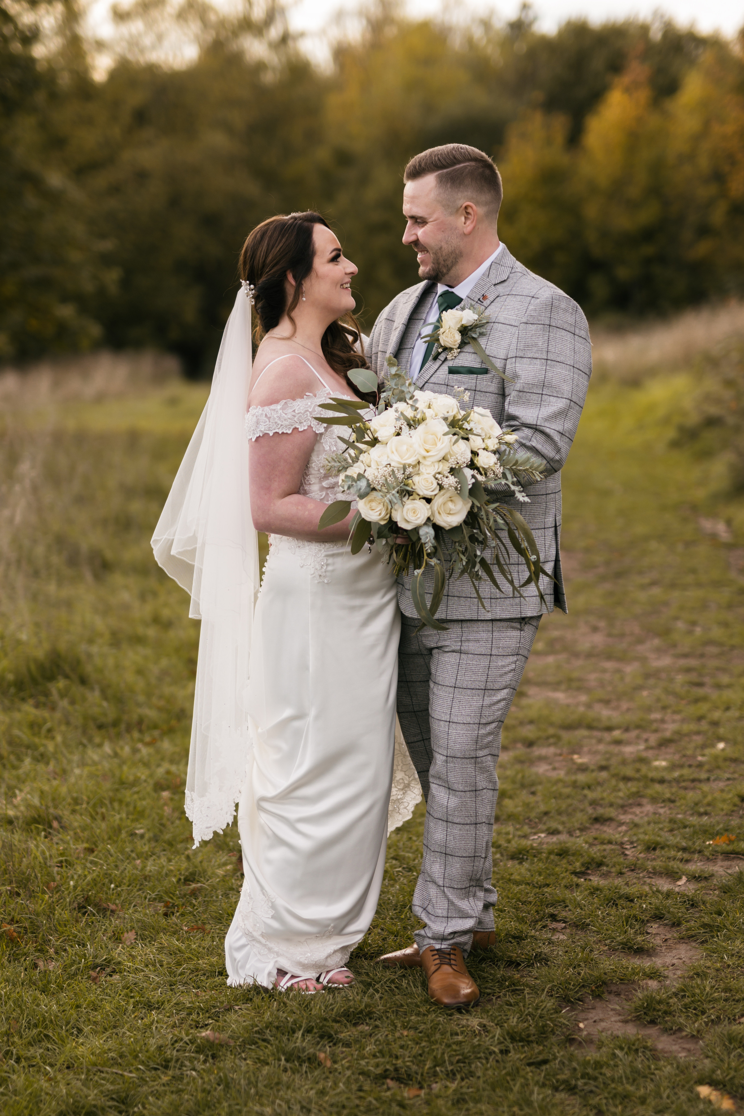 "Romantic shot of couple embracing in front of historic Aston Hall in Sheffield, taken by wedding photographer near you"