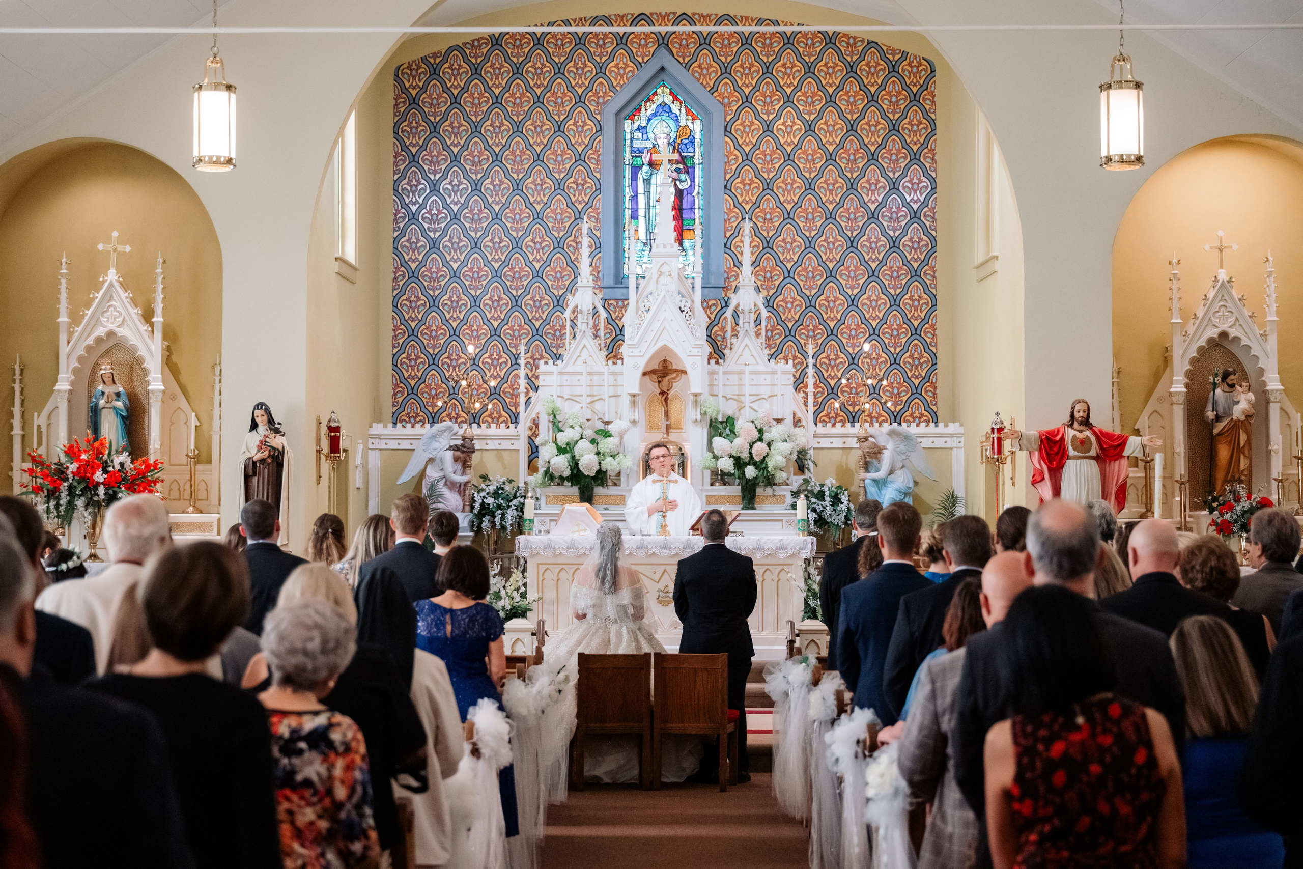 a wedding ceremony in a church with a bride and groom