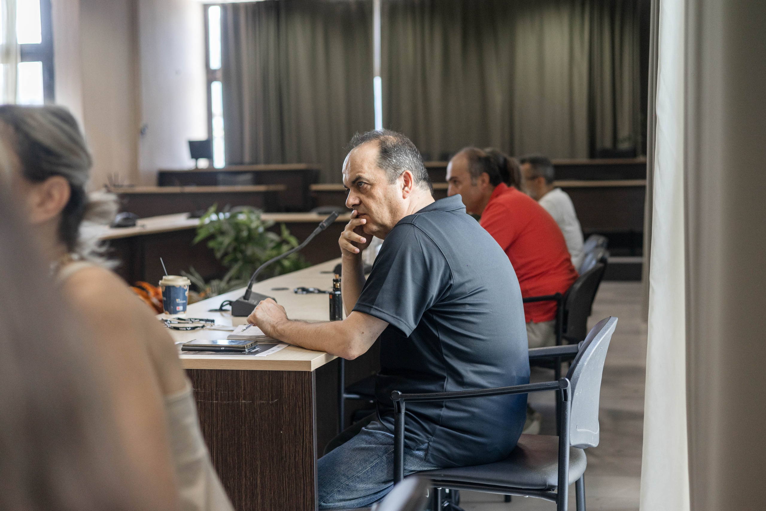 Journalist listening during a conference presentation