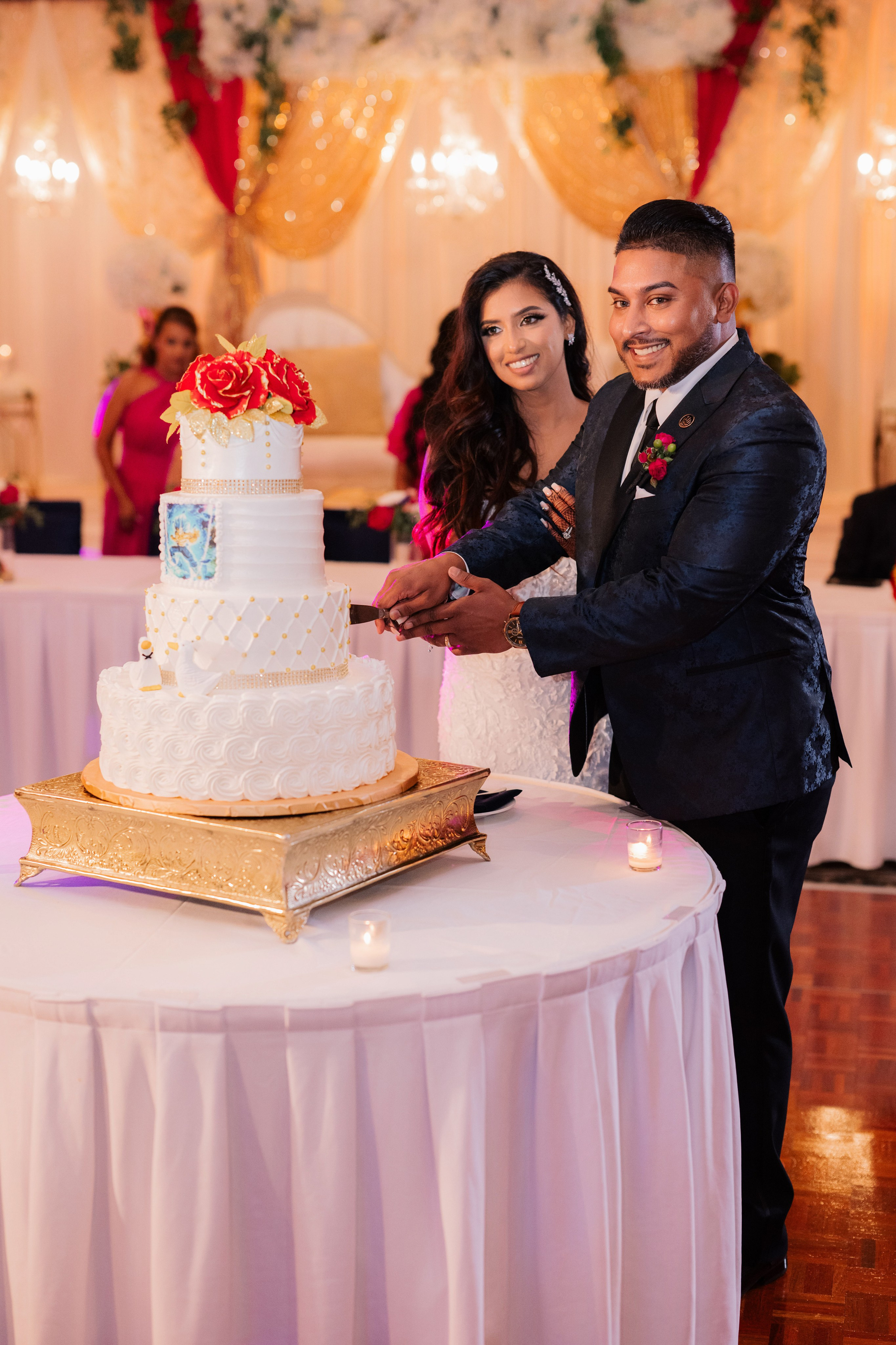 a man and woman cutting a cake together