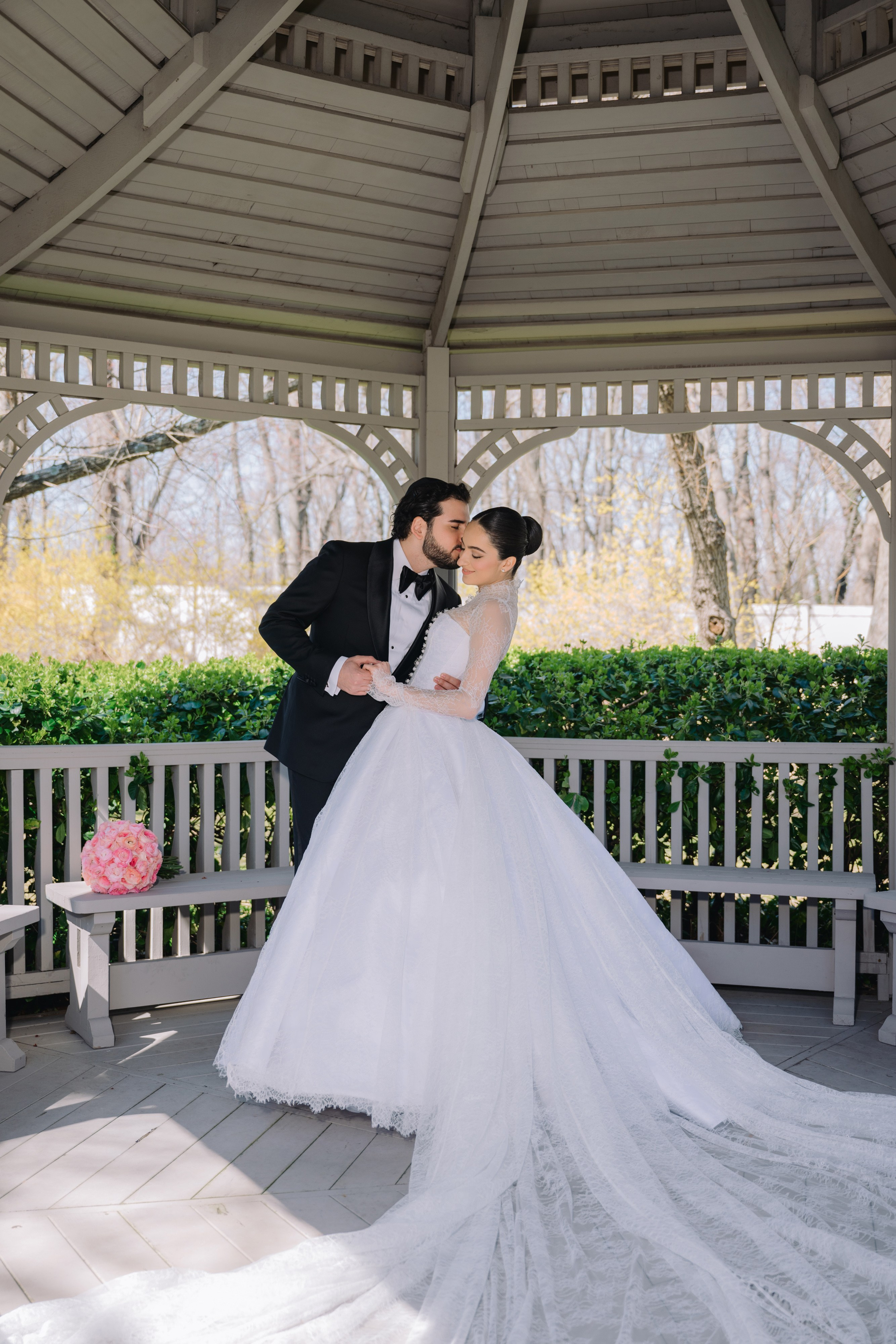 a bride and groom kissing on a gaze