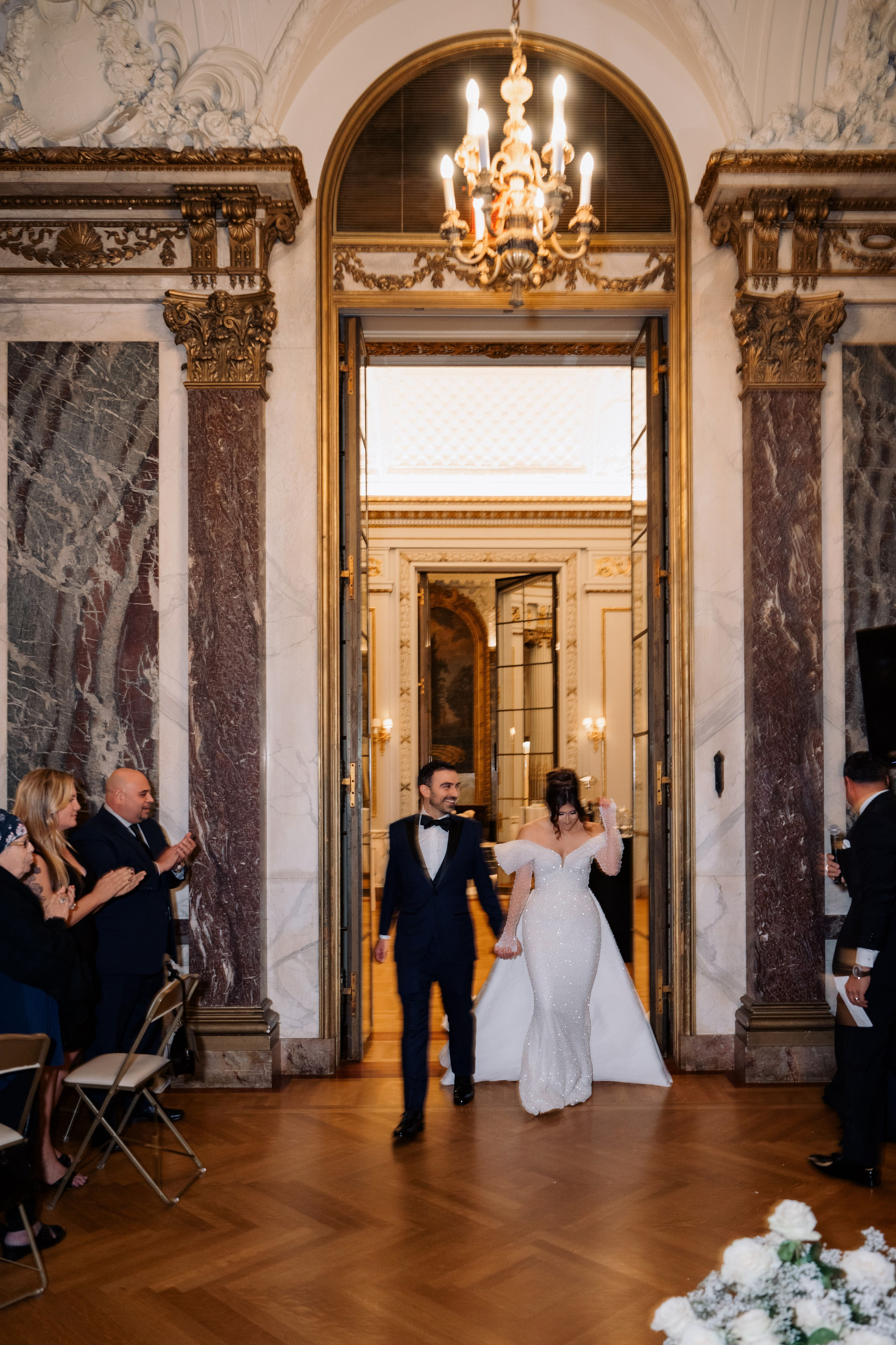 a bride and groom walking down the aisle