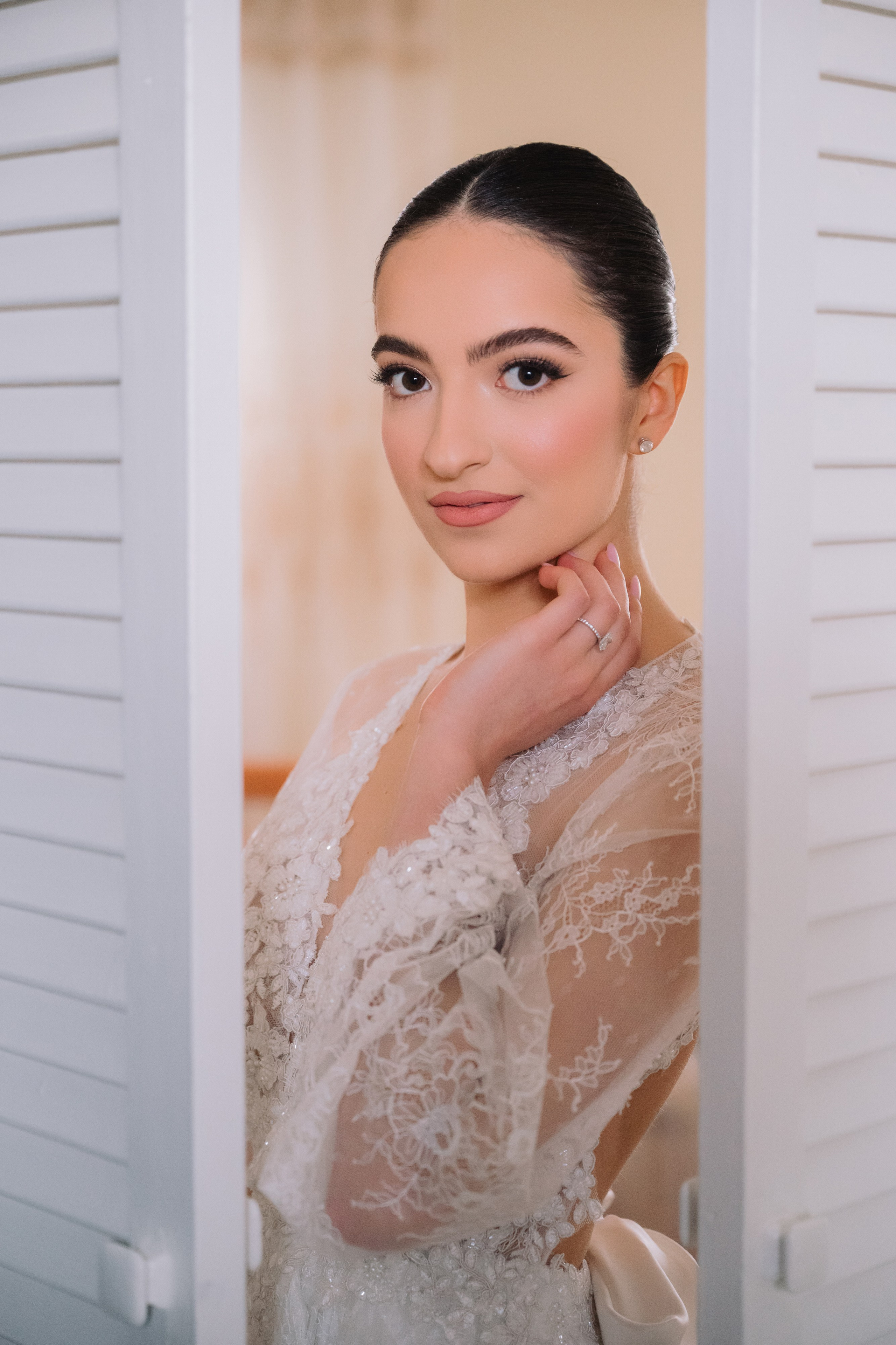 a woman in a white dress looking into the camera