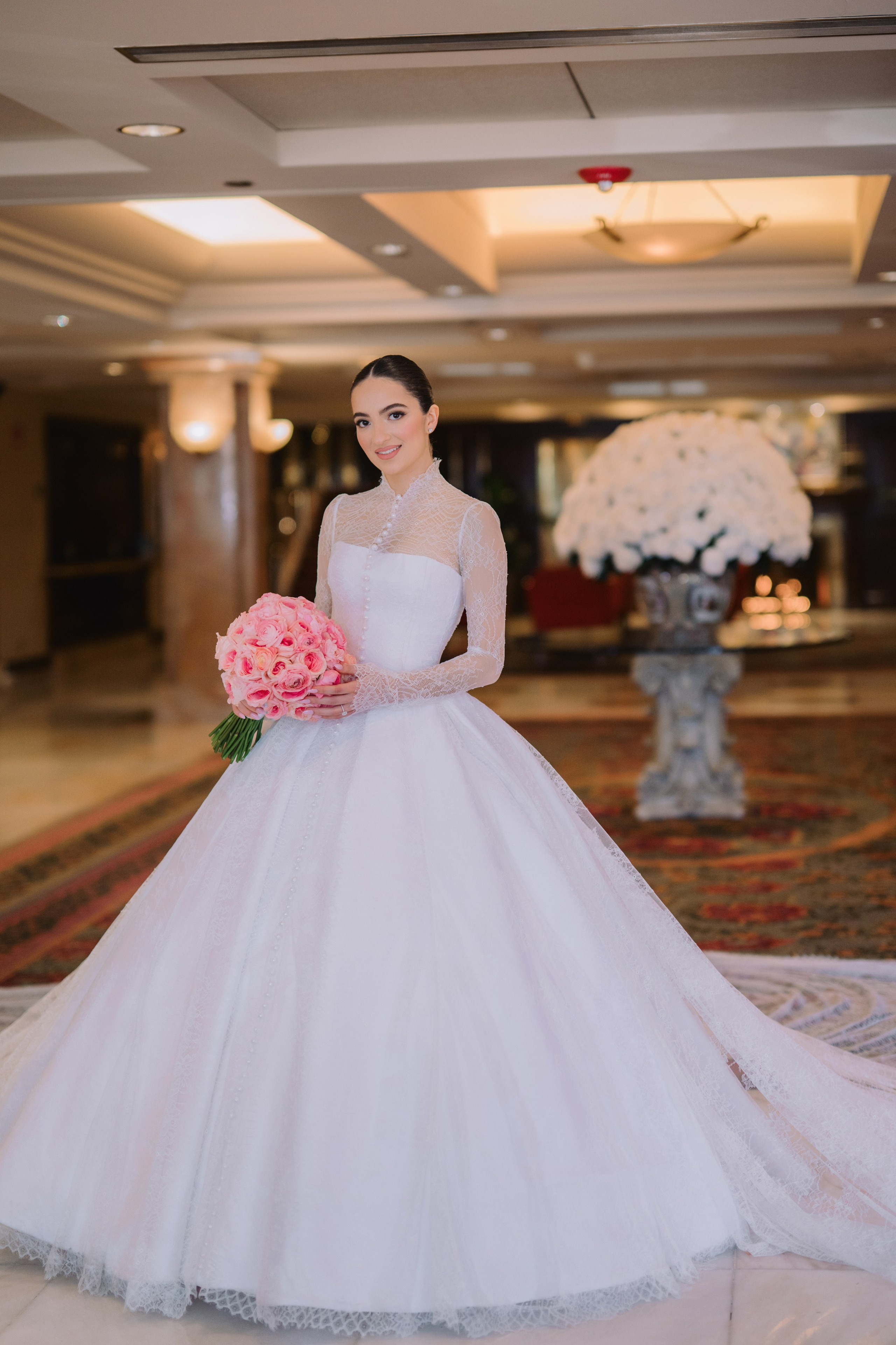 a bride in a white wedding dress standing on a rug