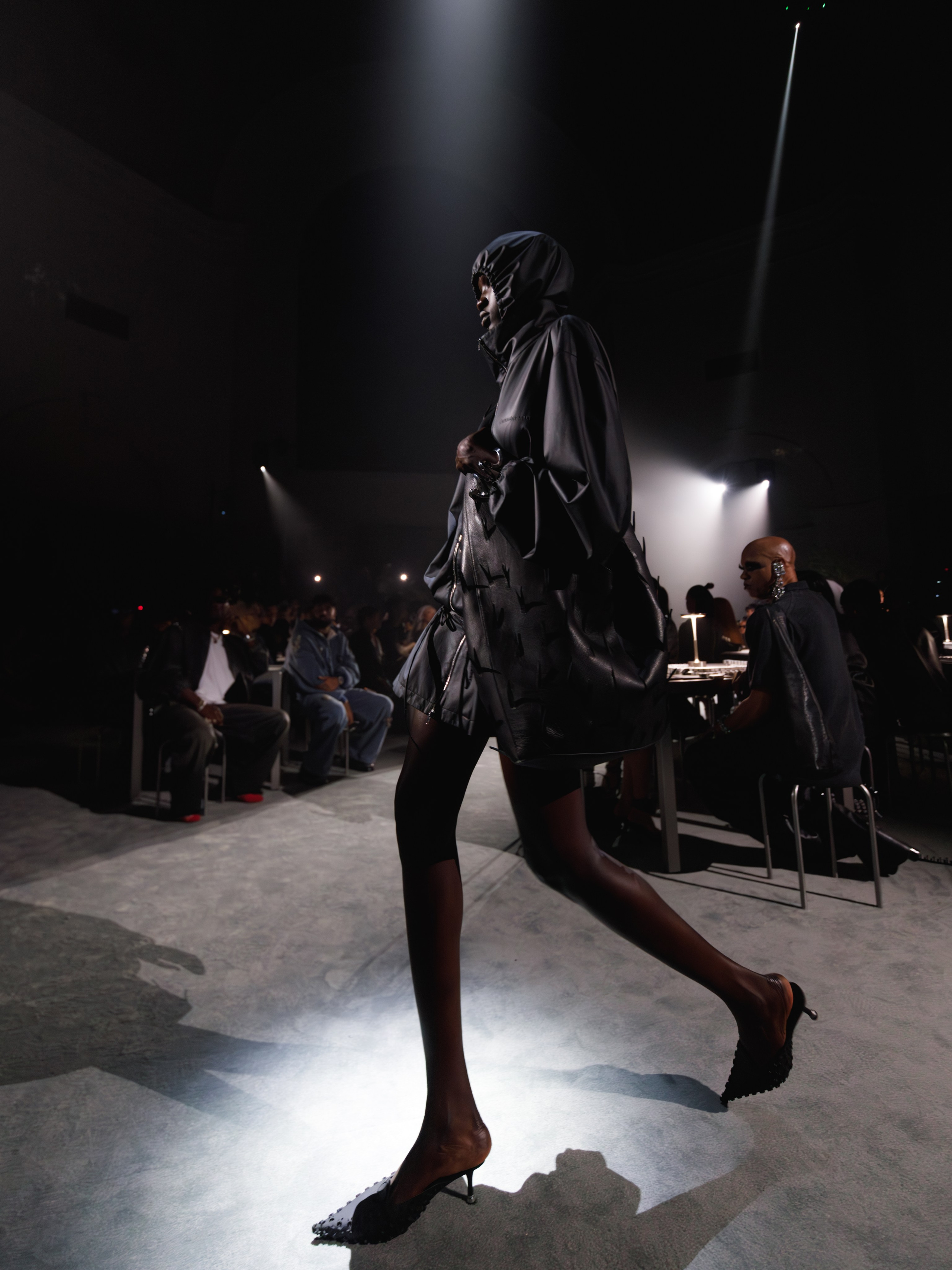 Evening fashion event with dark audience lighting – atmospheric runway shot