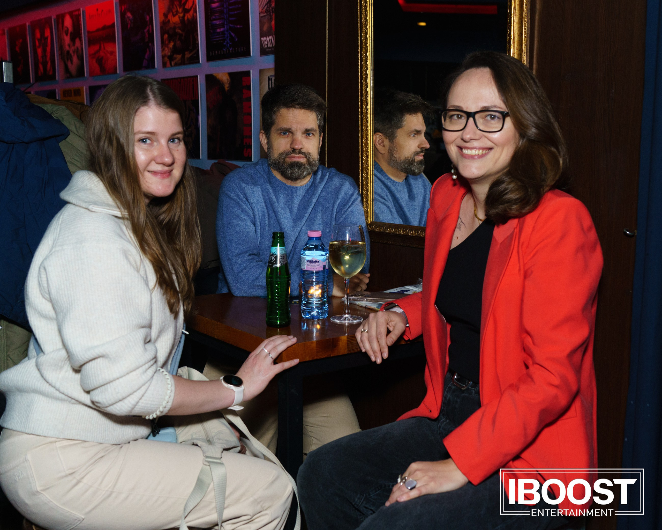 Three concert guests sitting at a table with drinks during the Animal JazZ concert in Sofia.
