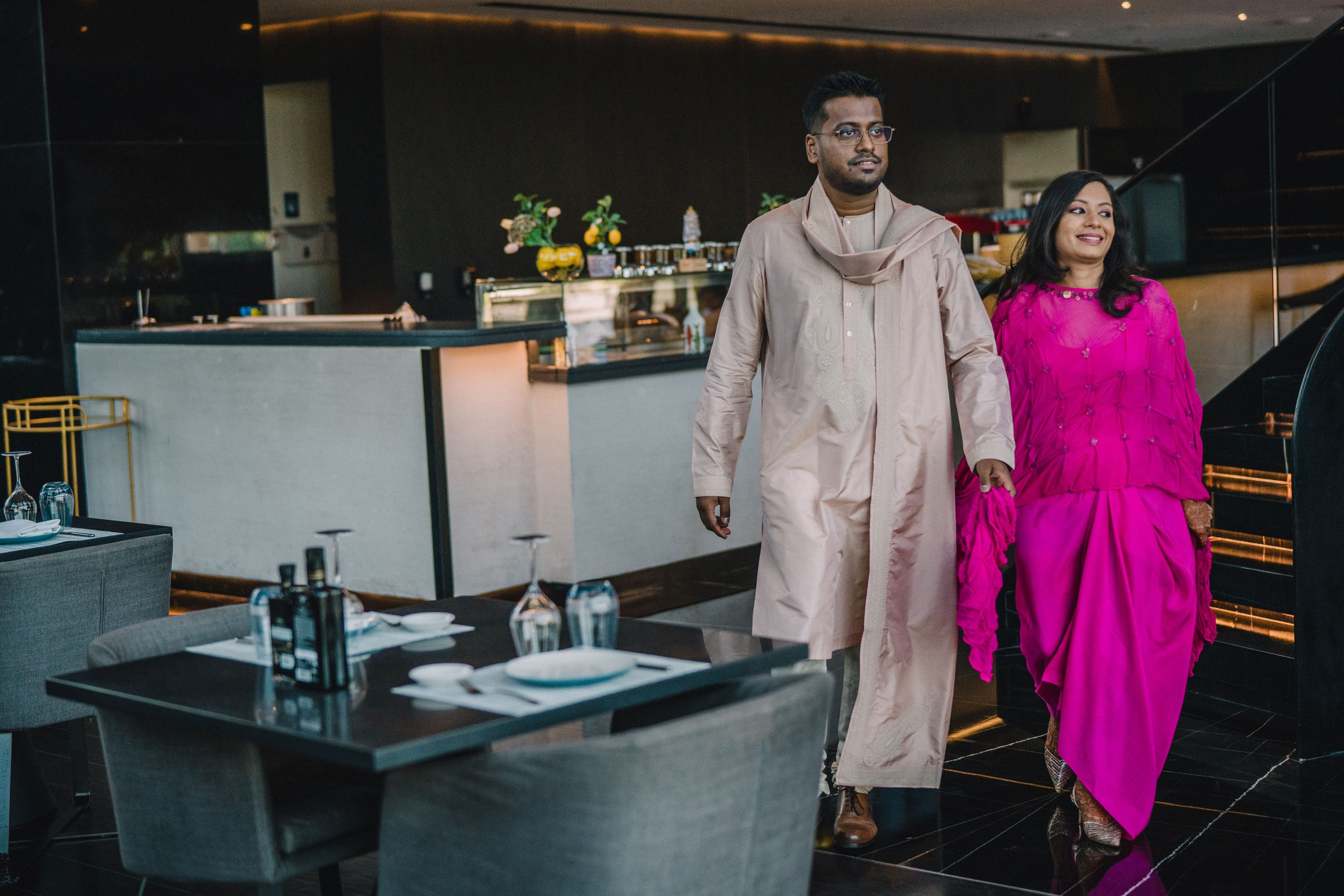 Indian couple, groom in a biege sari and bride in a purple sari