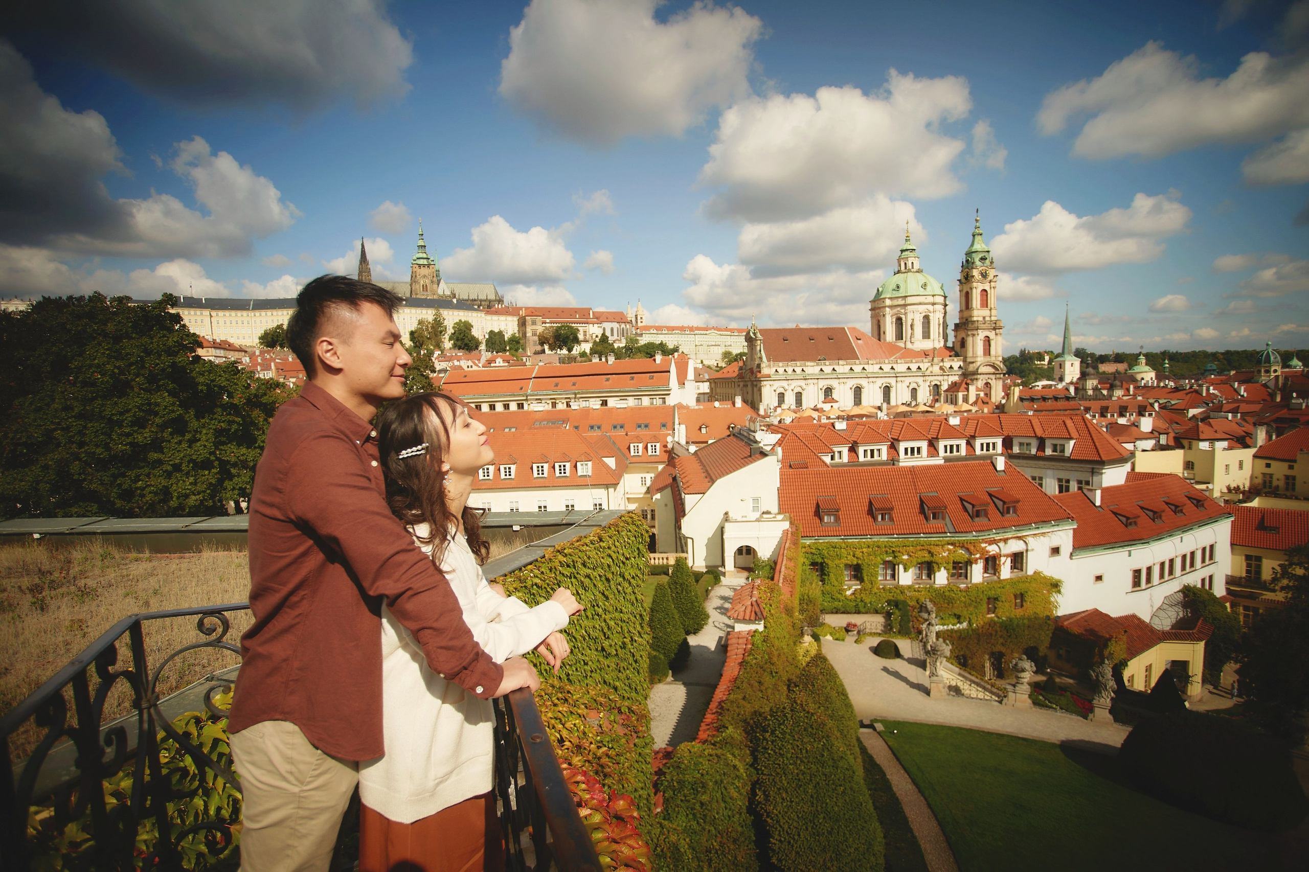 Newlyweds Eva and Conan are enjoying the sunlight and the view at the top of Vrtba Garden.