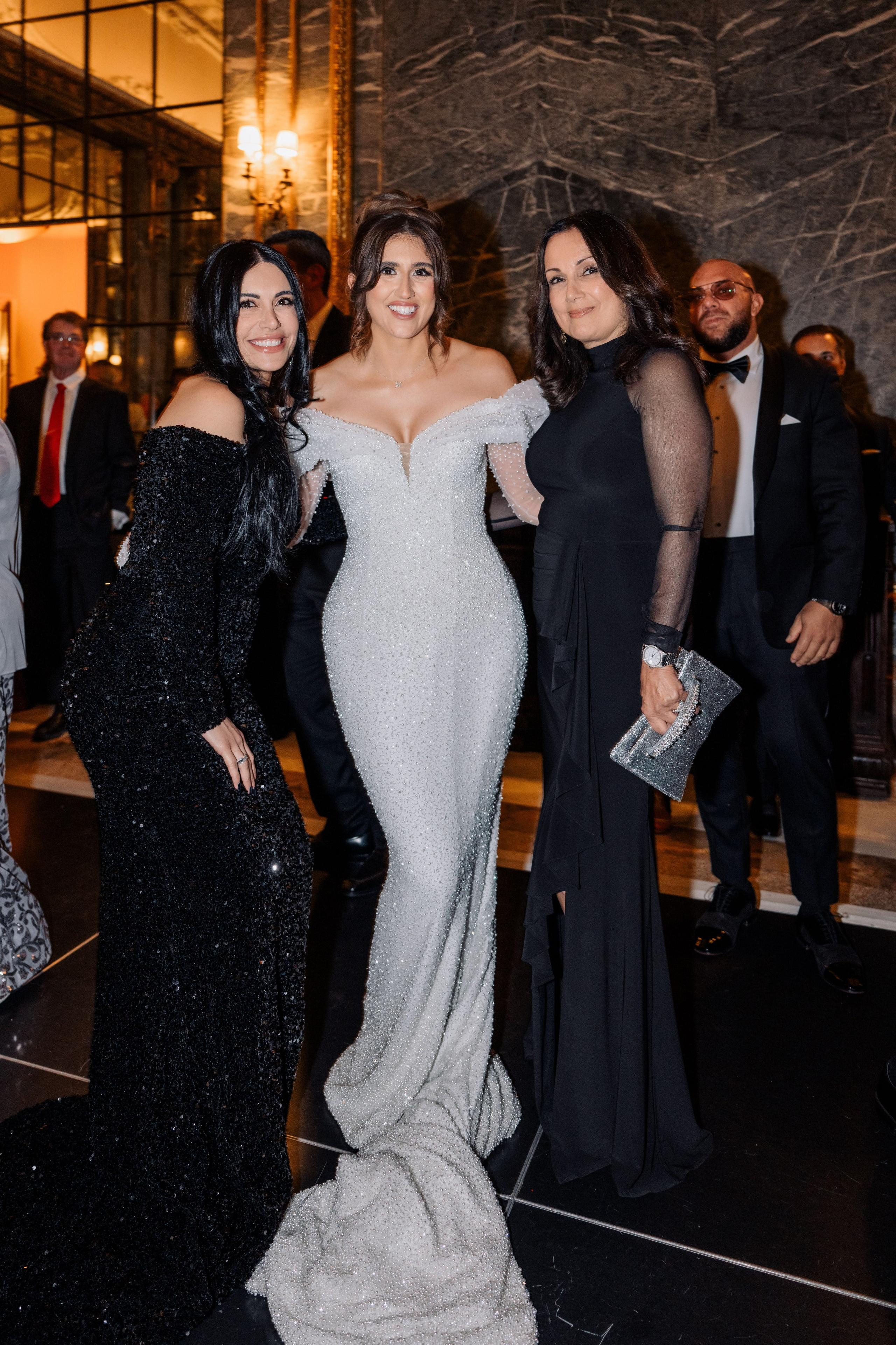 two women in formal dresses posing for a photo