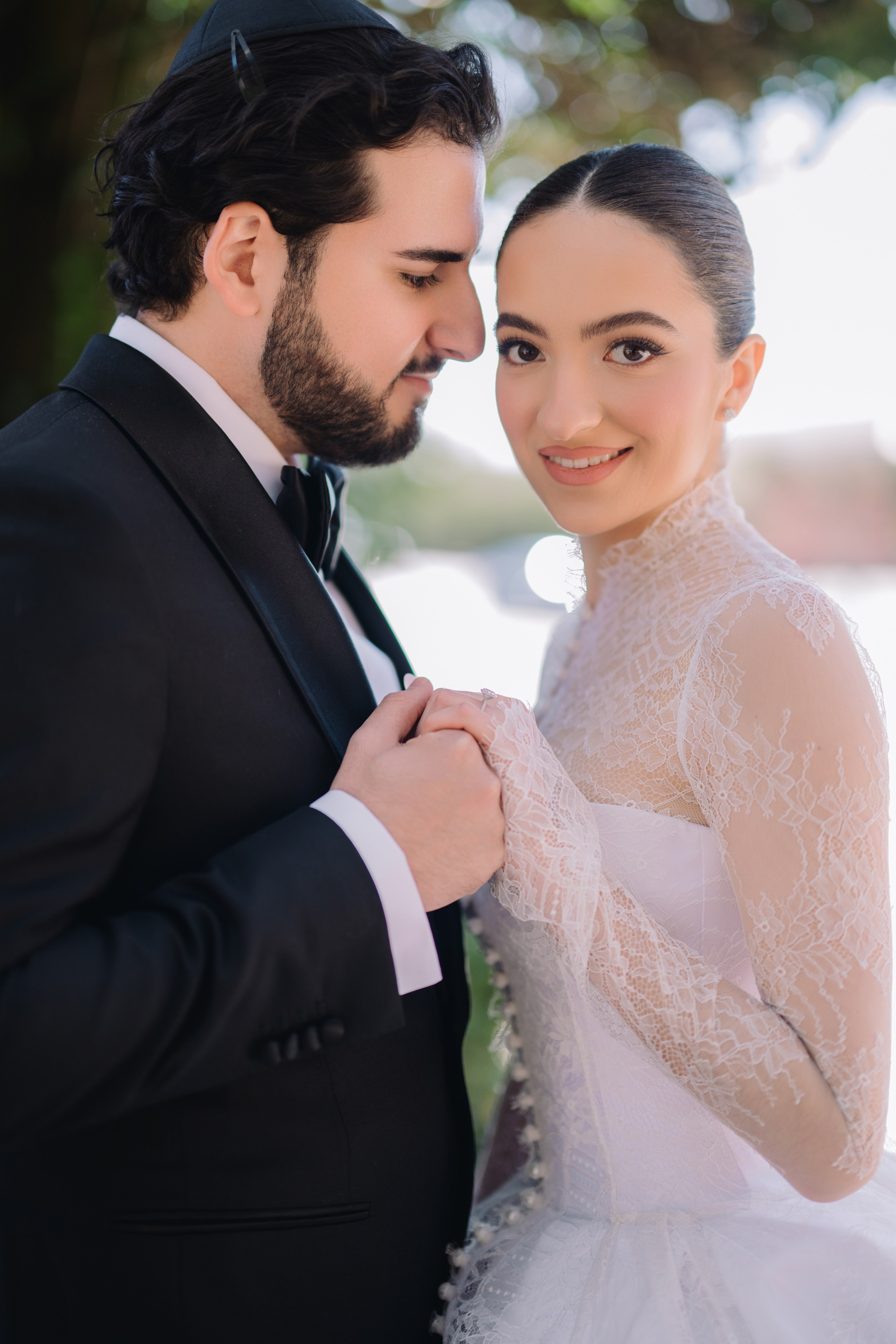 a bride and groom pose for a photo