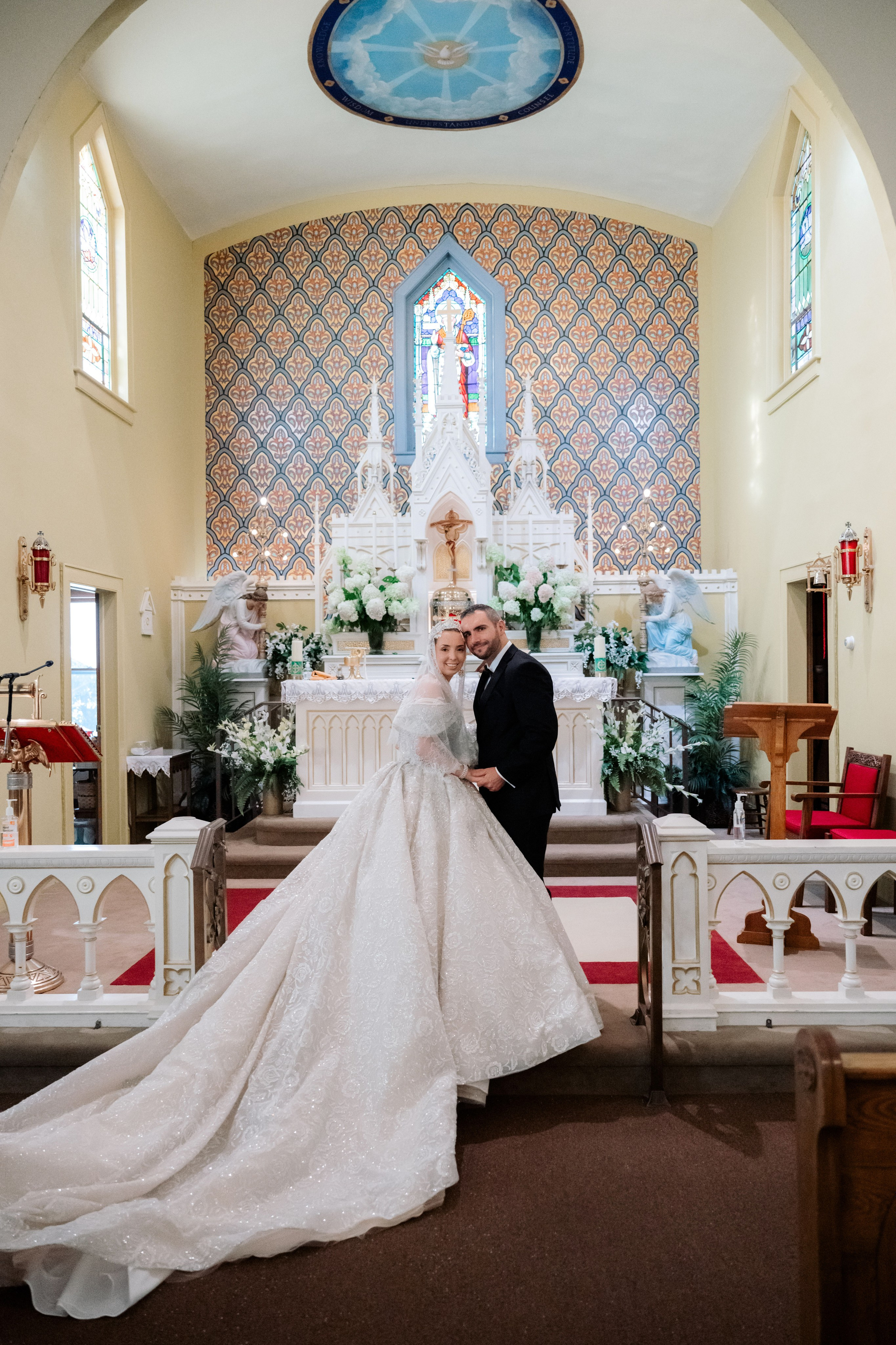 a bride and groom are sitting in the church