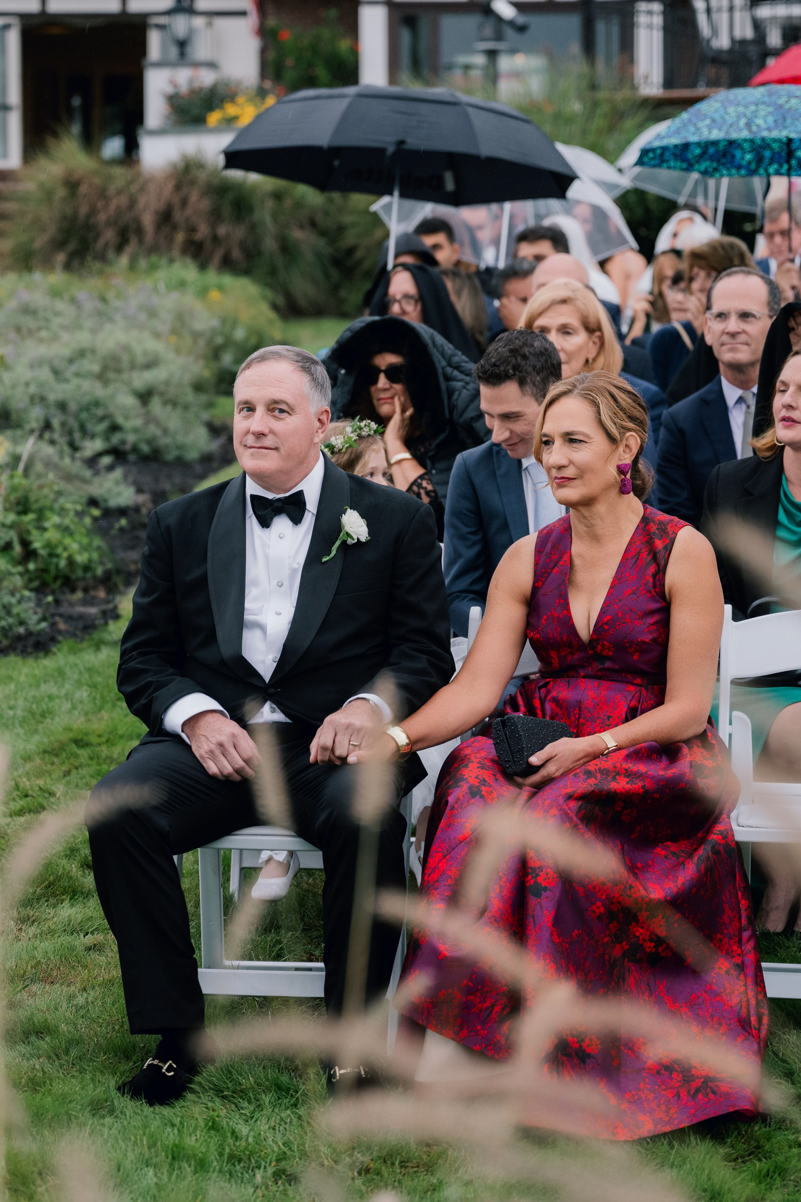 a couple sitting on a bench in a garden