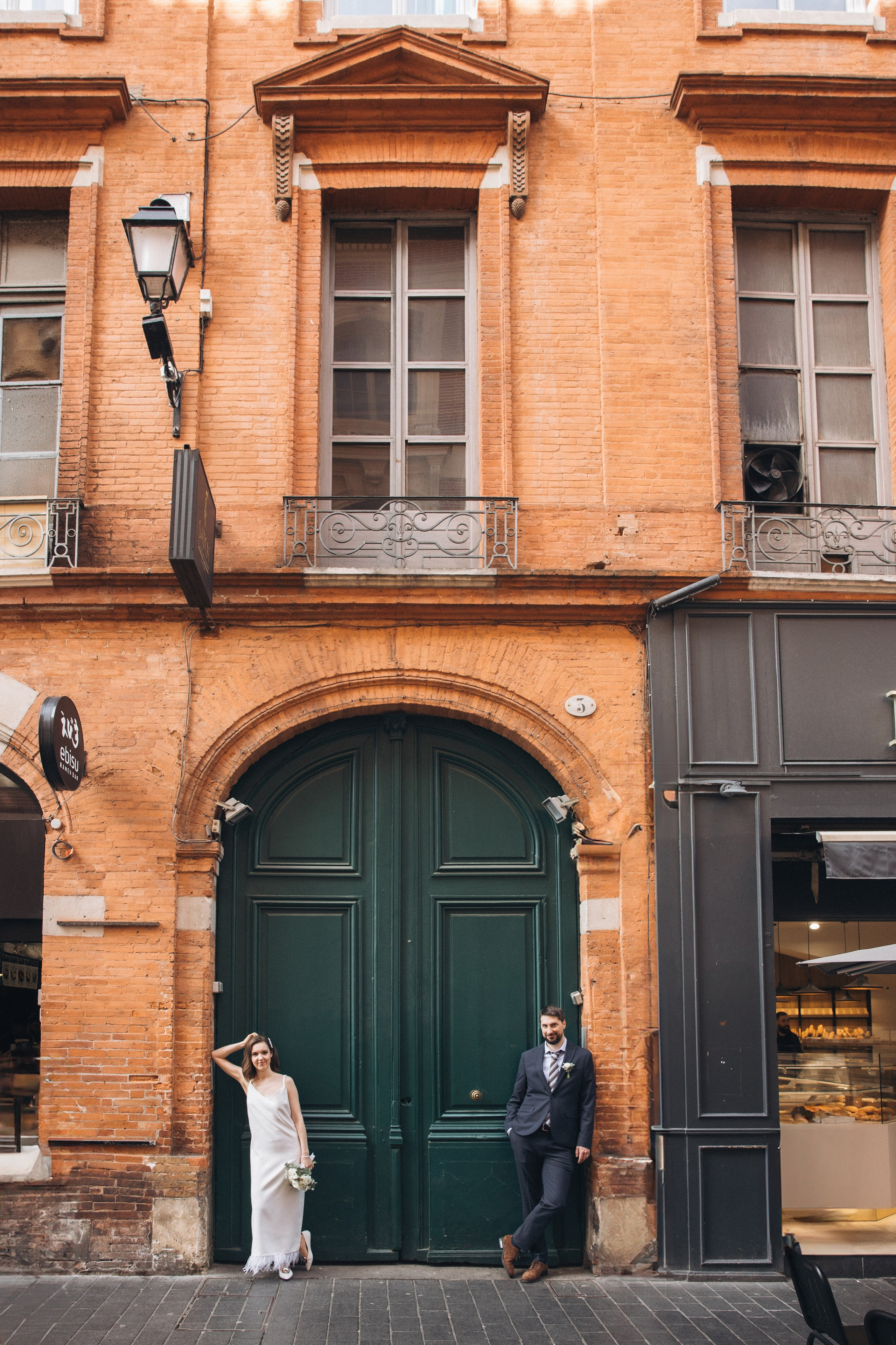 Couple of the newlyweds walking on the streets of Toulouse