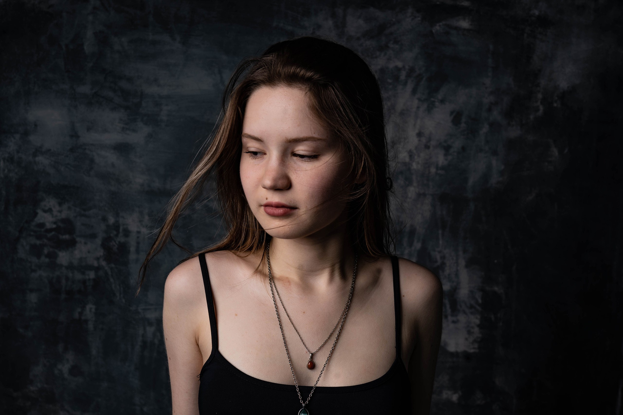 Portrait photography, content photo, portrait of a girl, studio dark background