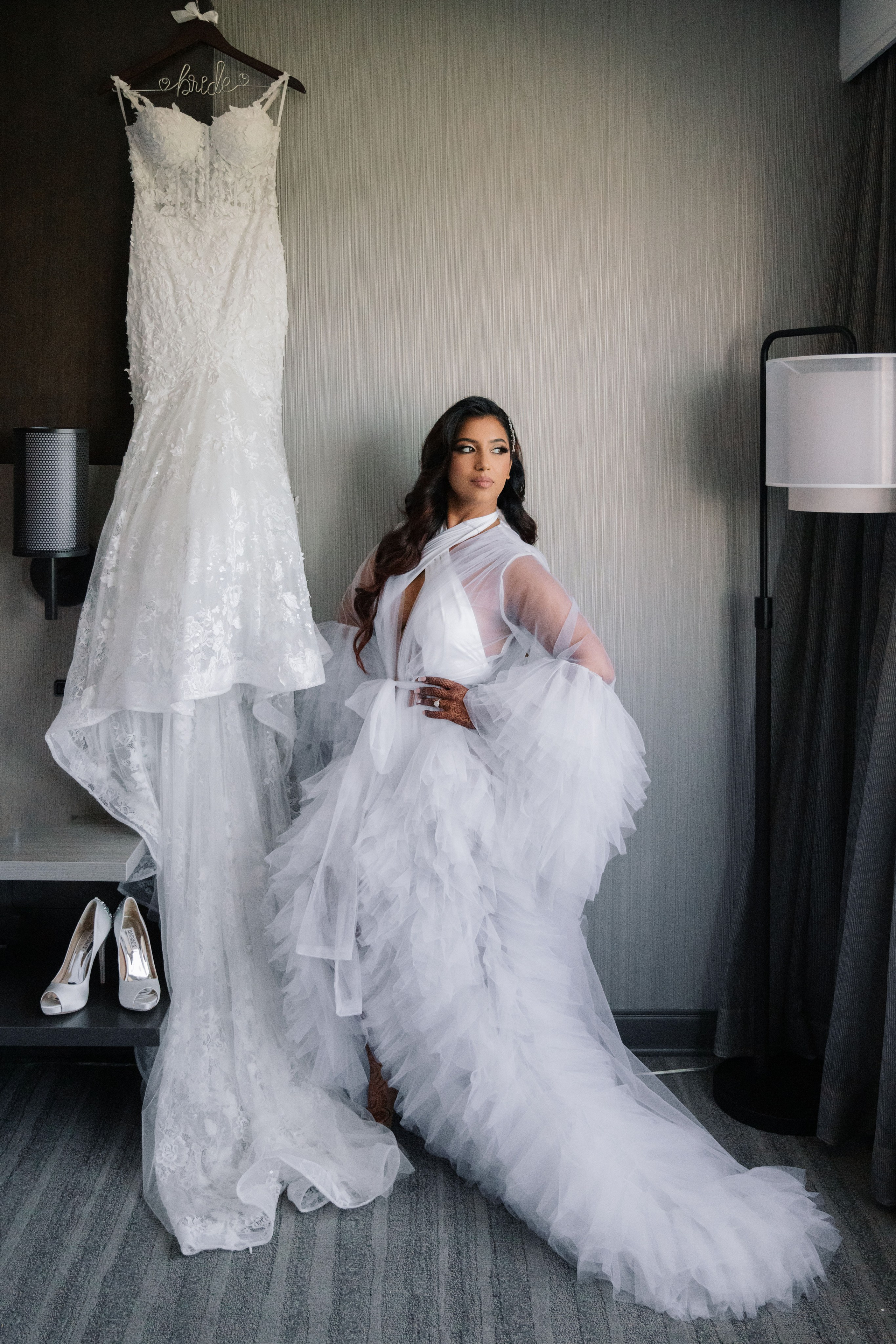 a woman in a wedding dress sitting on a bed
