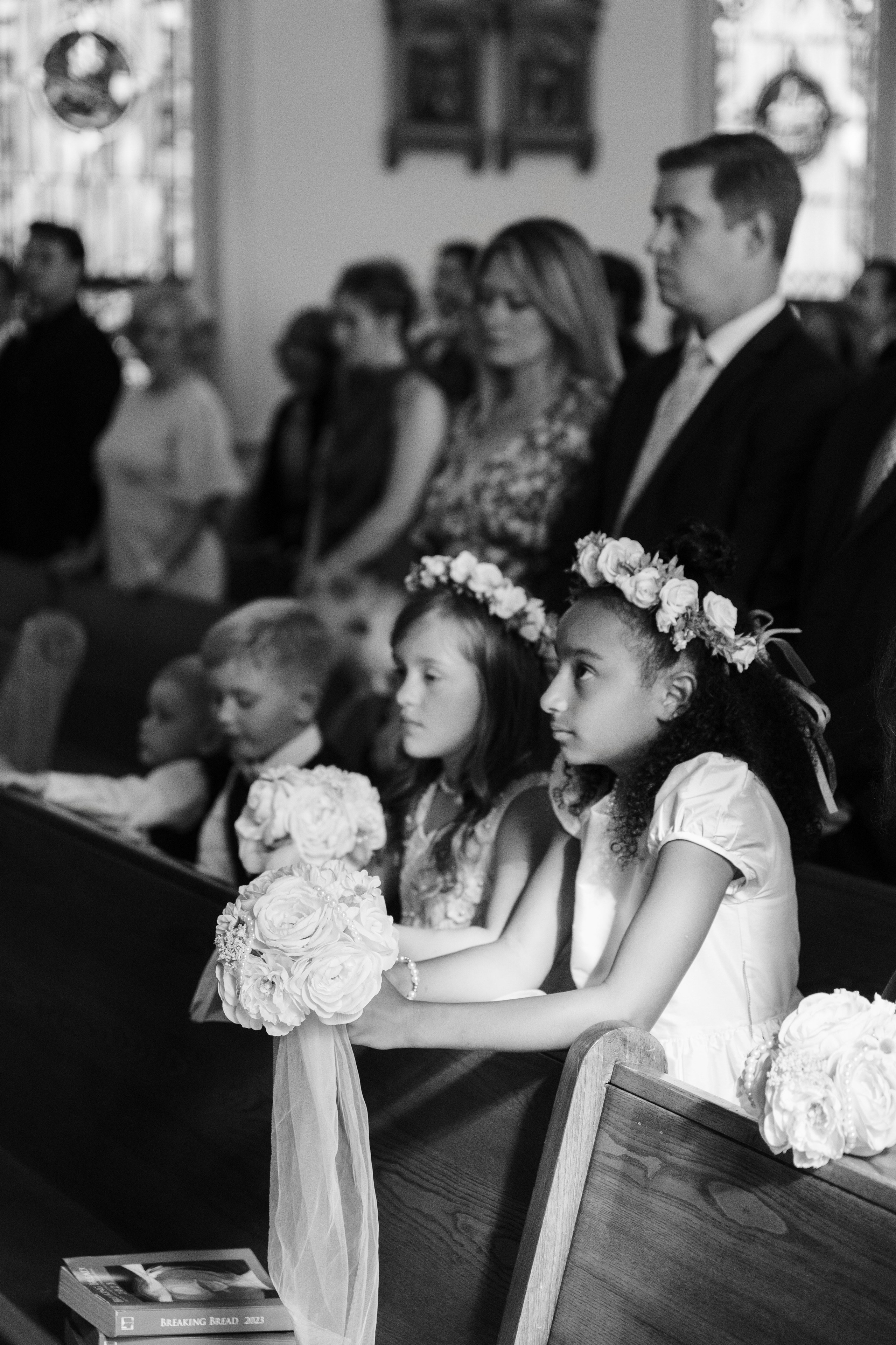 a little girl sitting in a church pew pew