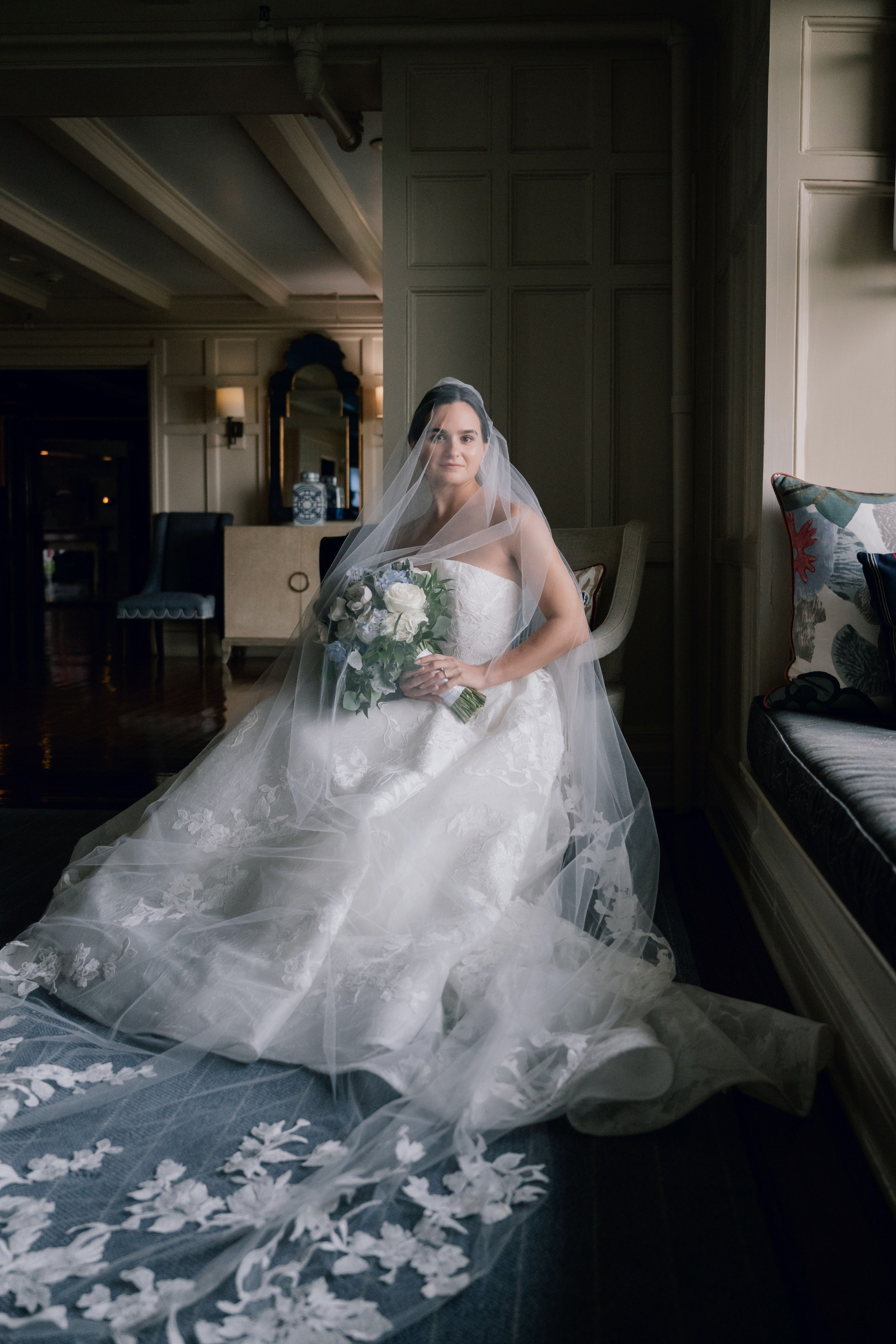 a bride sitting on a bed in a hotel room