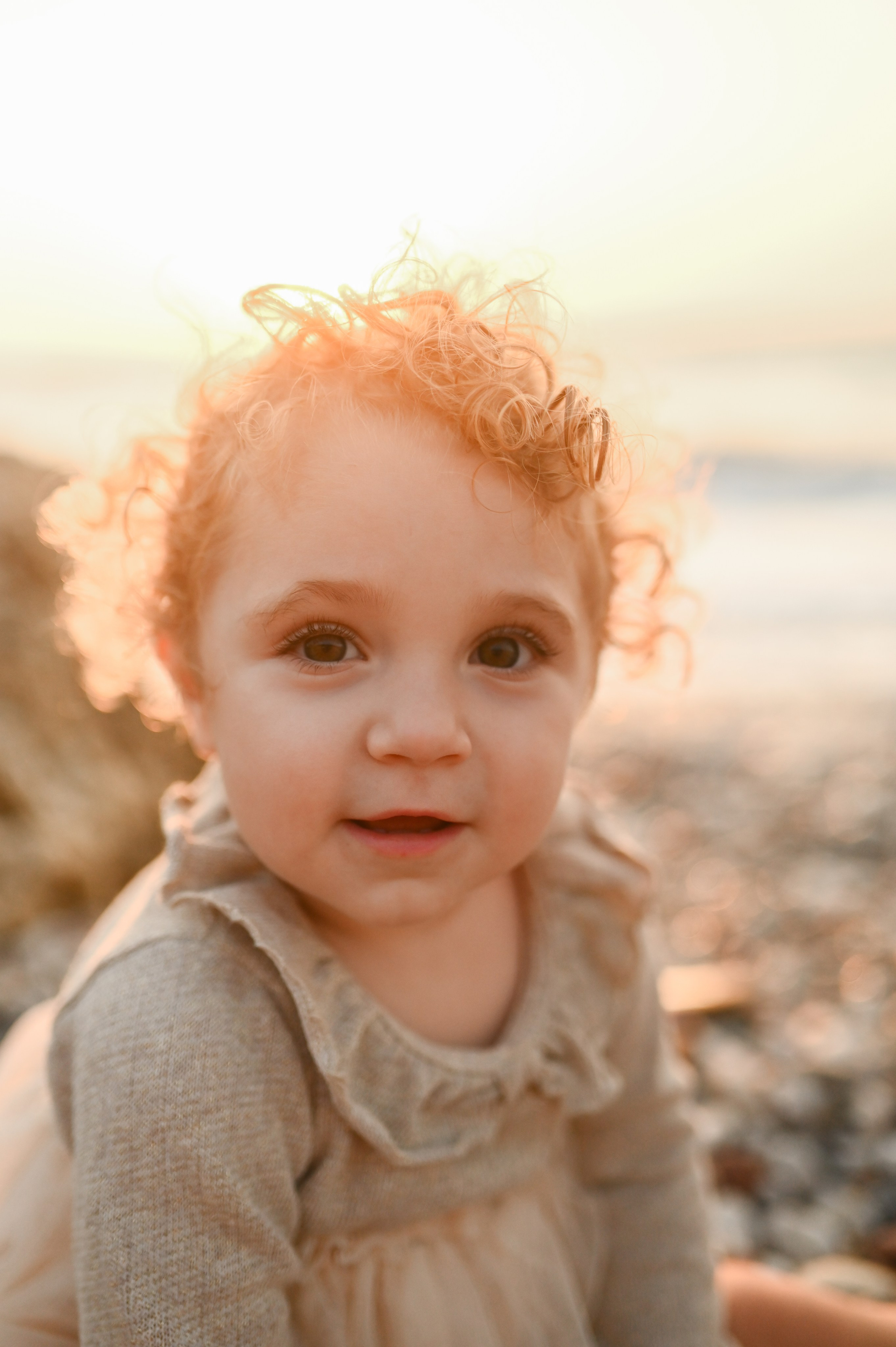 Happy family walking along a Rhodes beach at sunset. Photographer in Rhodes Island
