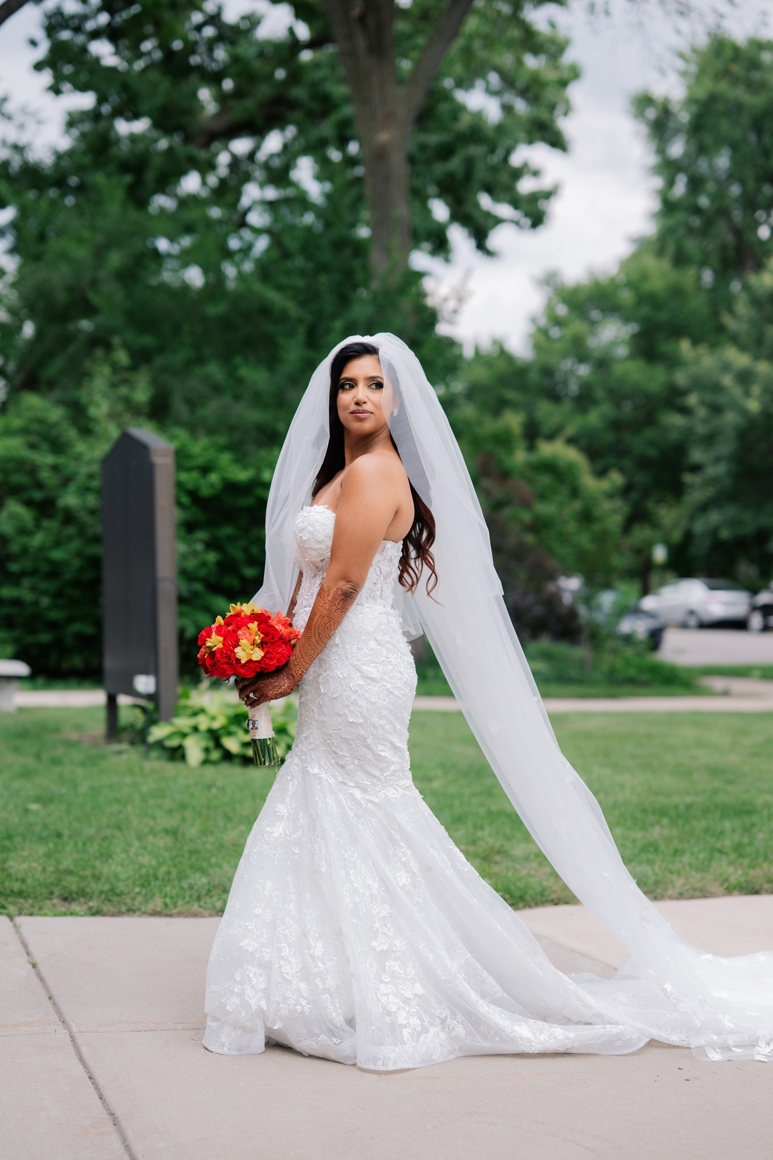 a bride in a wedding dress holding a bouquet