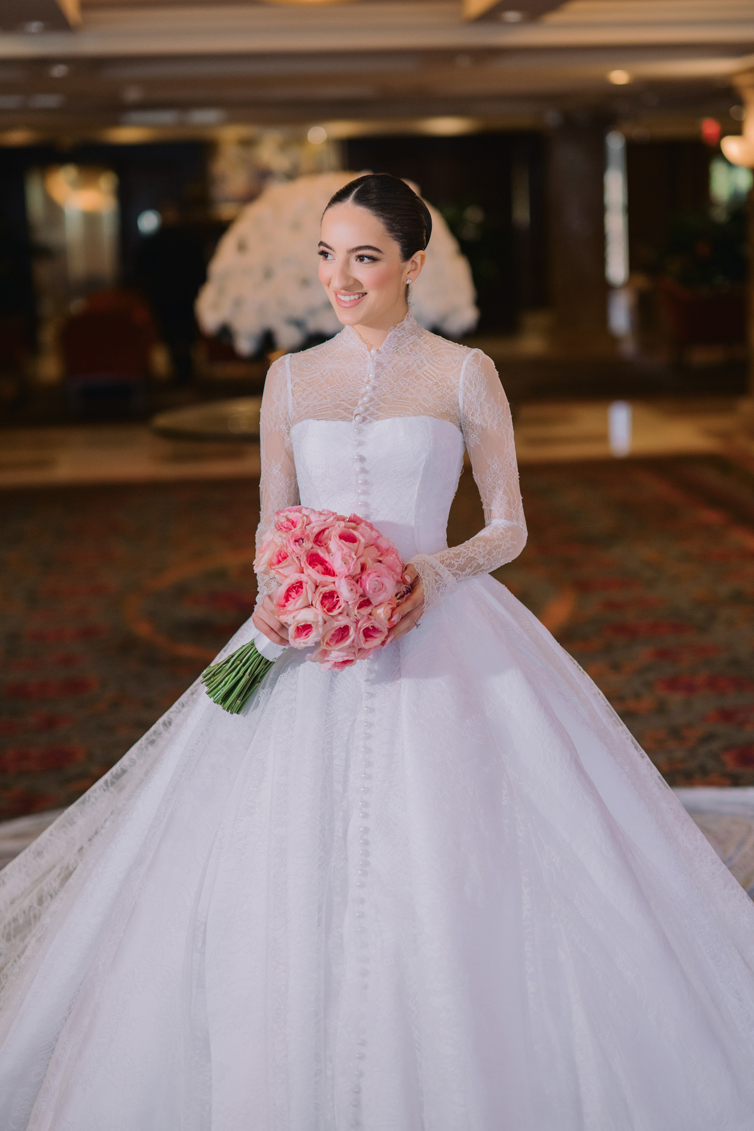 a bride in a white wedding dress holding a bouquet