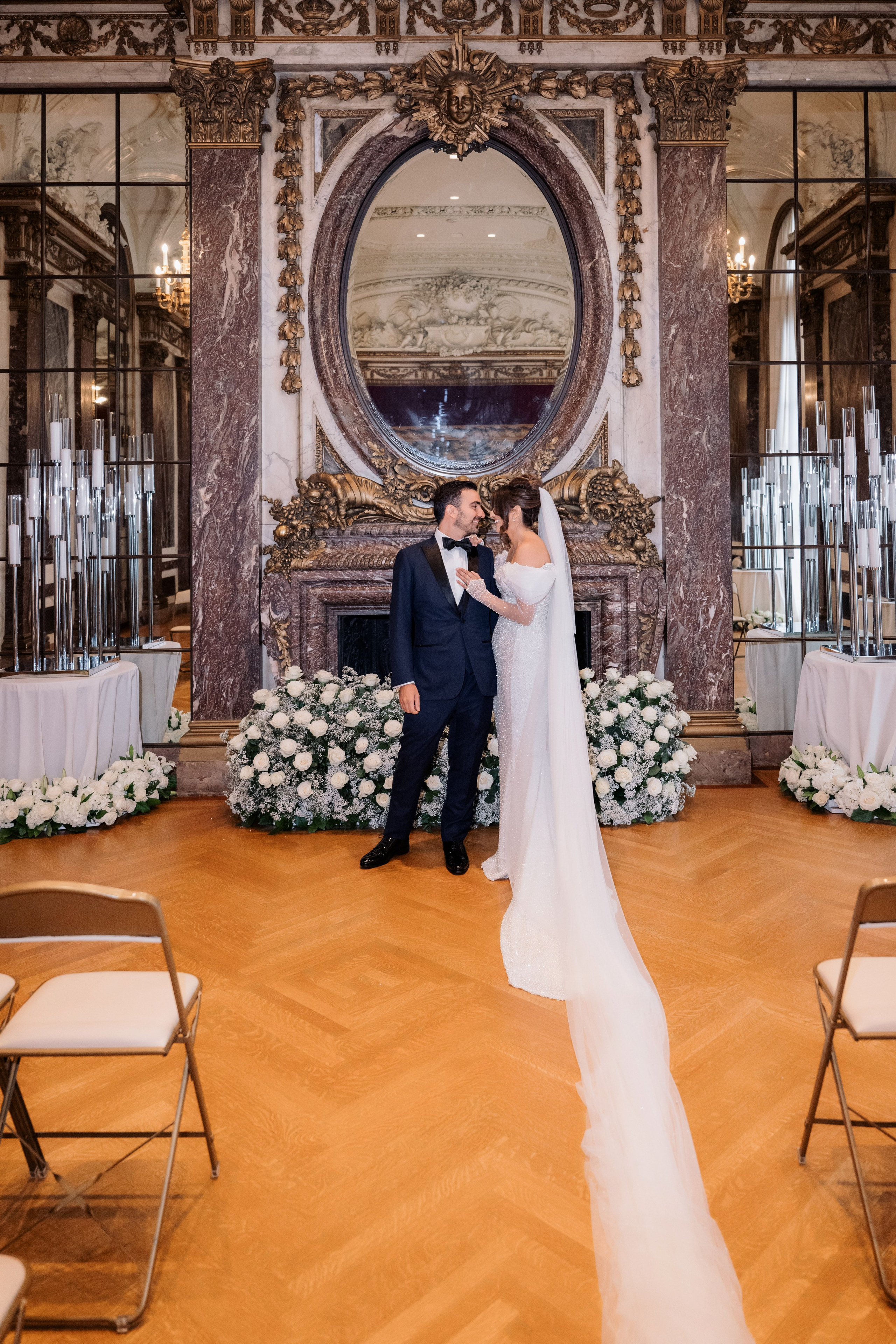 a bride and groom kissing in a ballroom