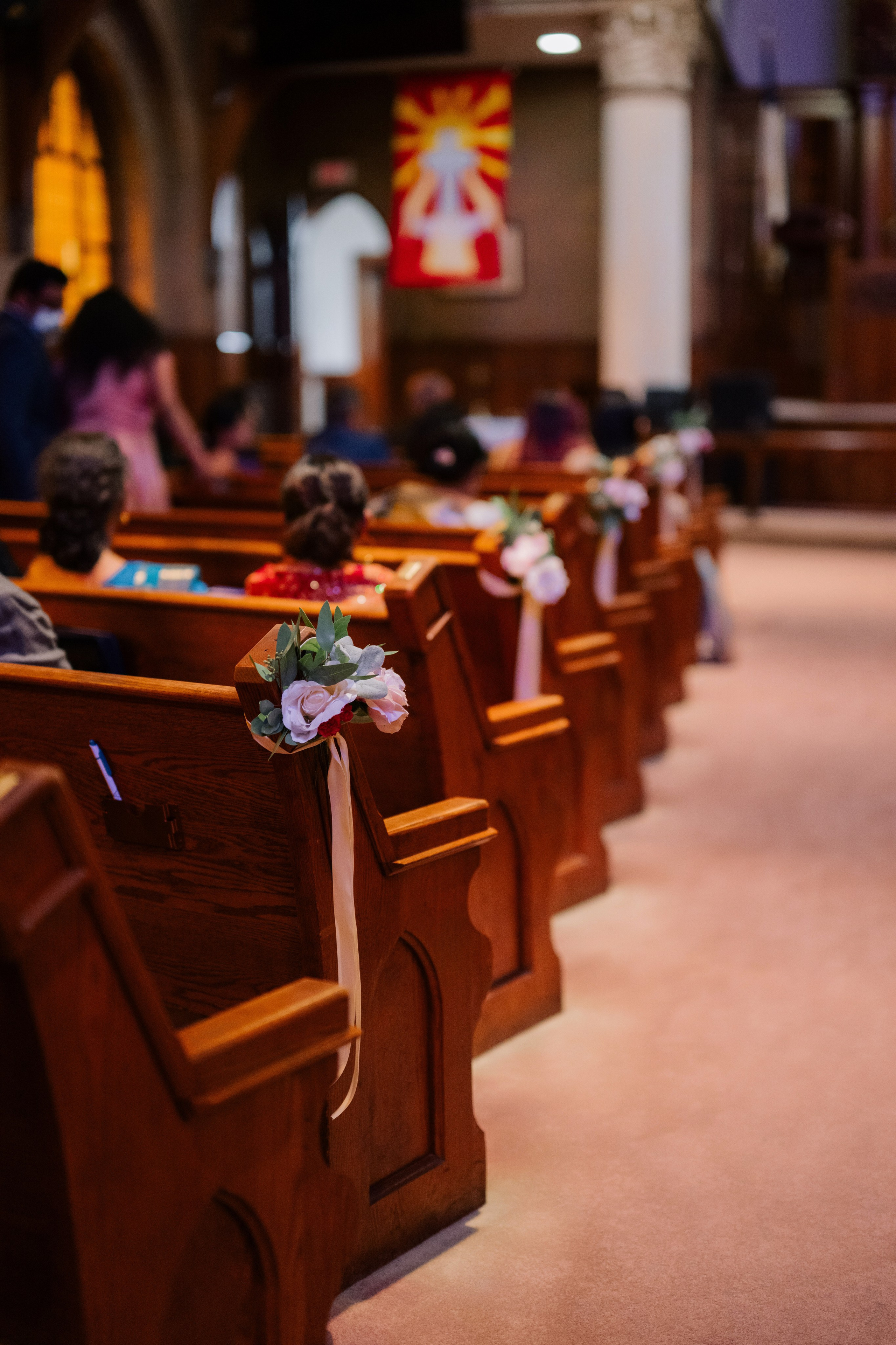 a bunch of flowers sitting in a church pew