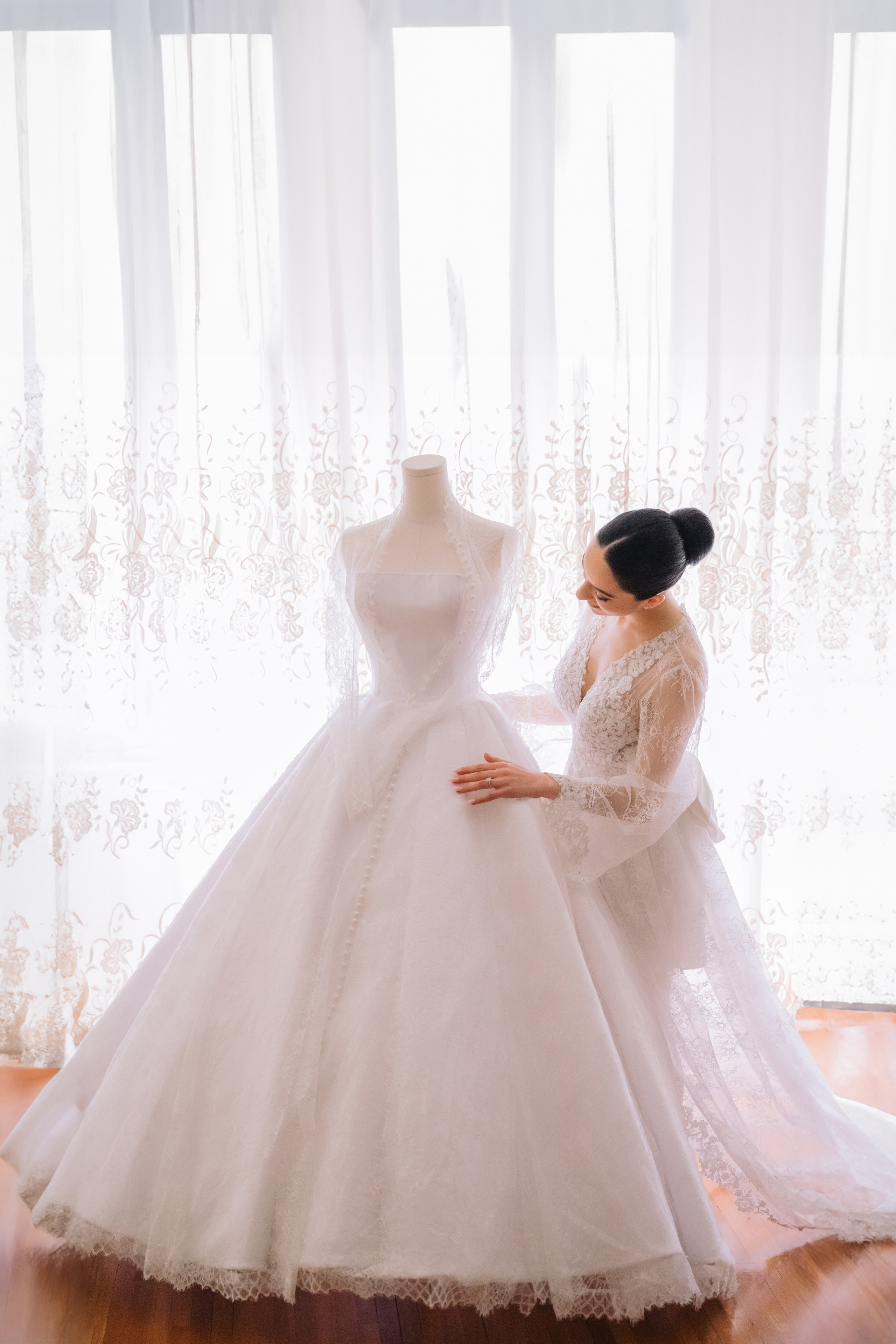 a woman in a wedding dress is looking at a dress