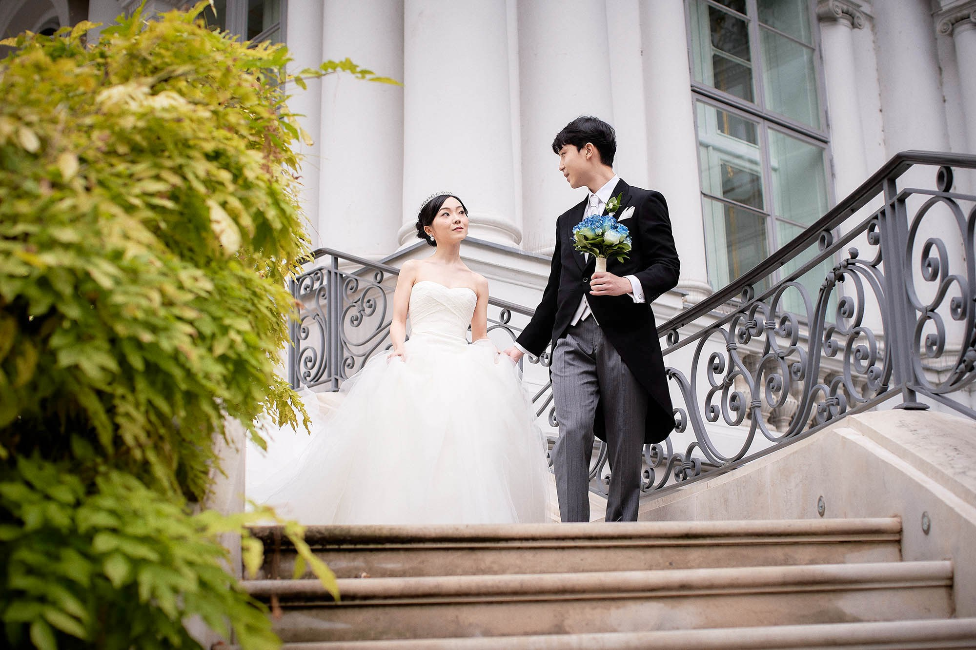 The young couple walks hand in hand down the same steps that princes and princesses once walked.
