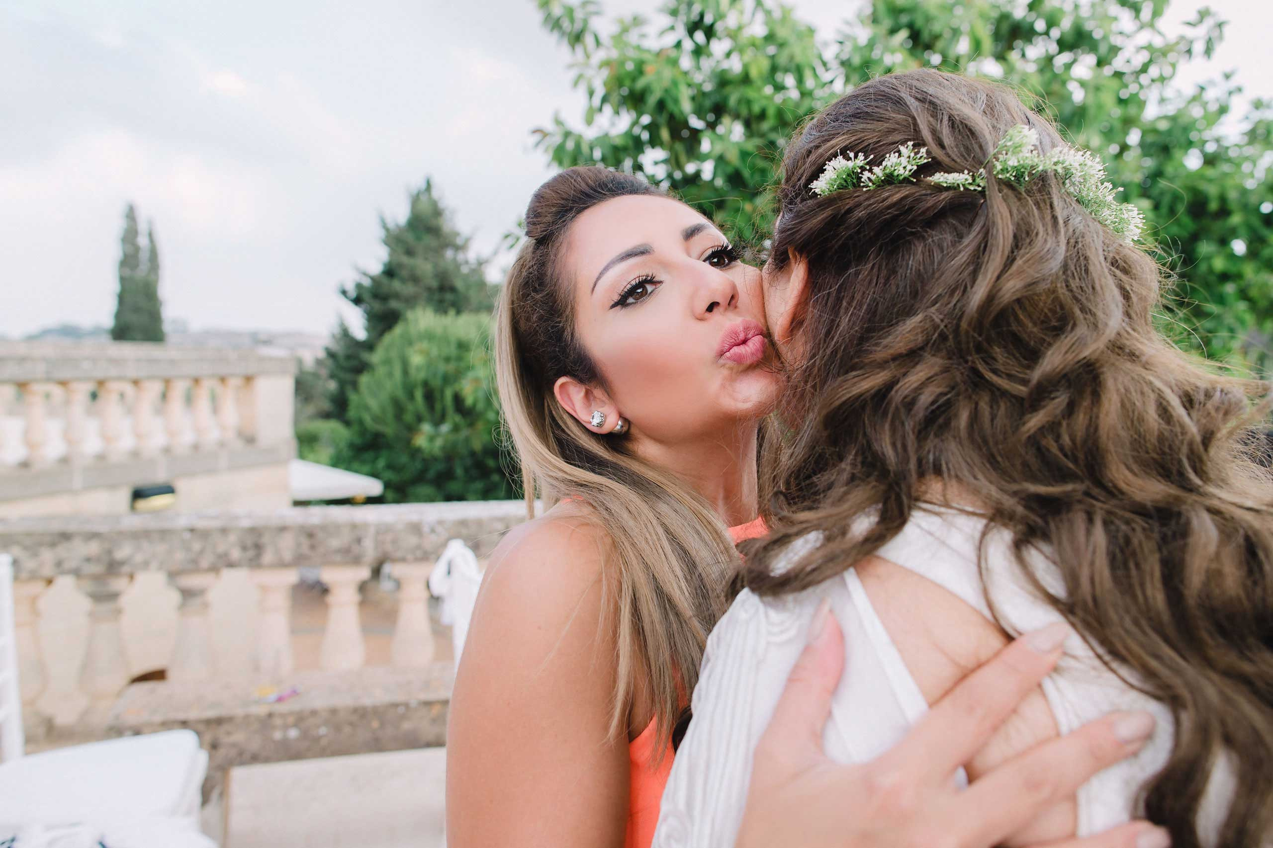wedding reception with bride and guest happily congratulating each other and kissing