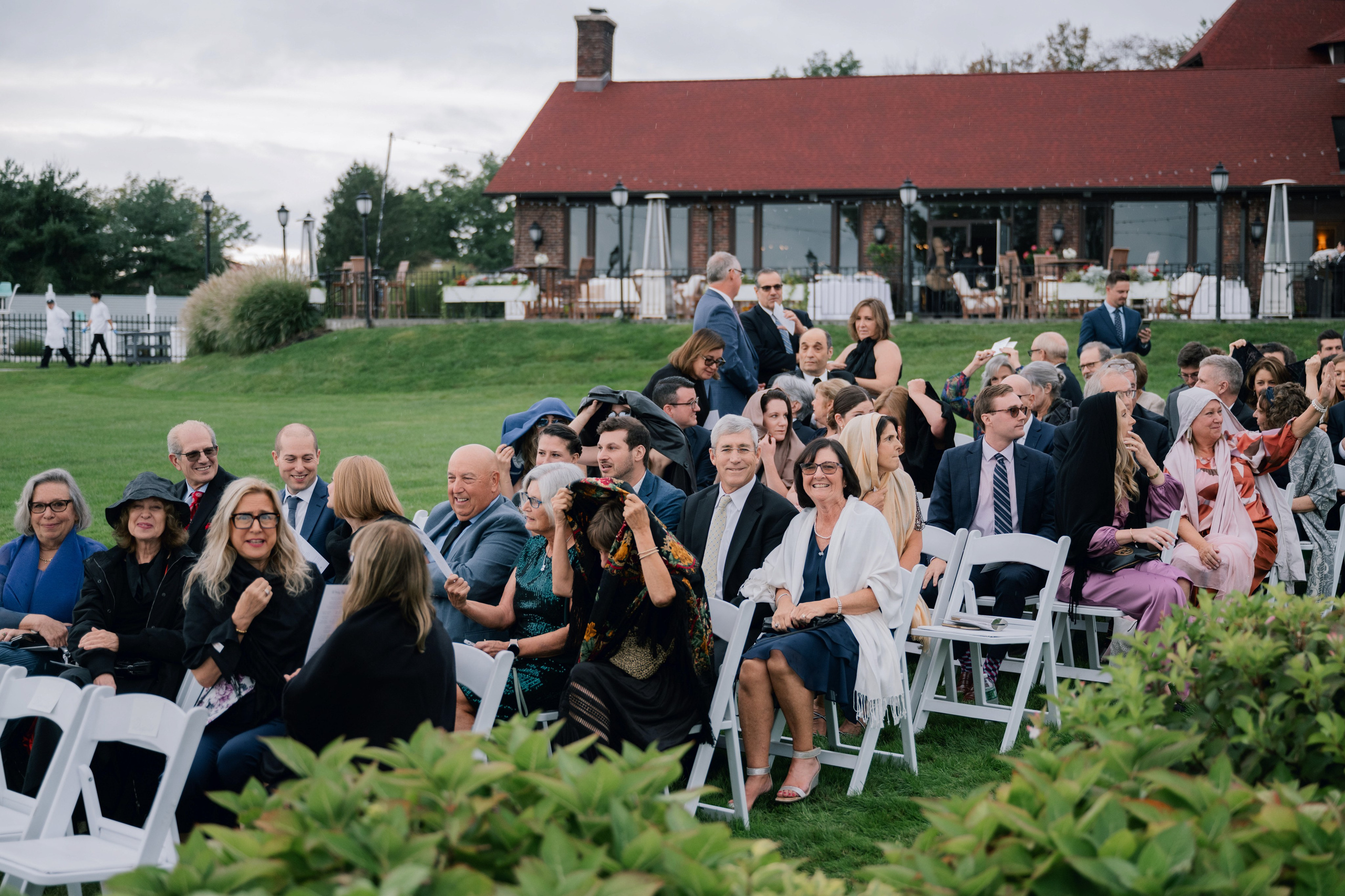a group of people sitting in chairs in a field
