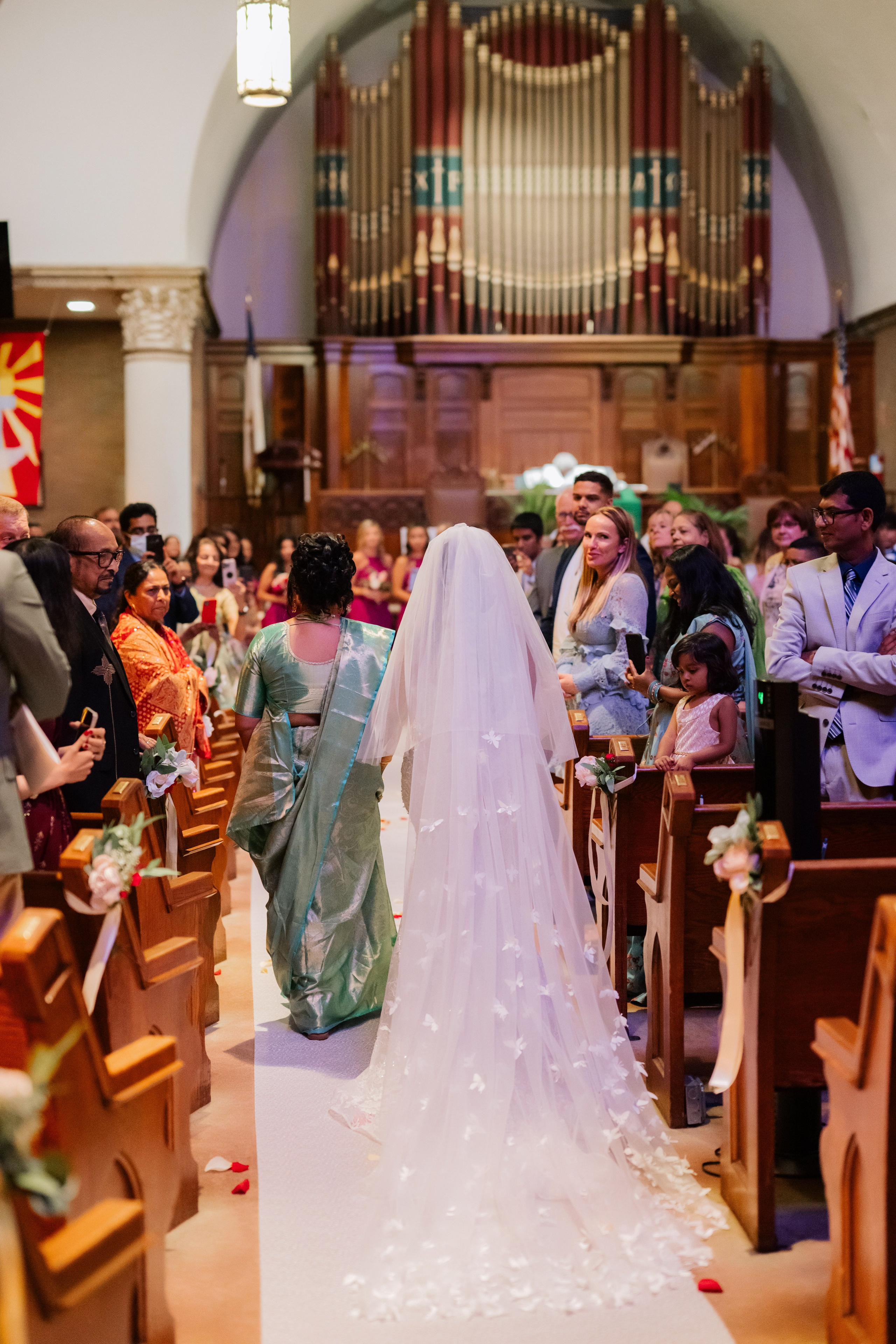a bride walking down the aisle of a church