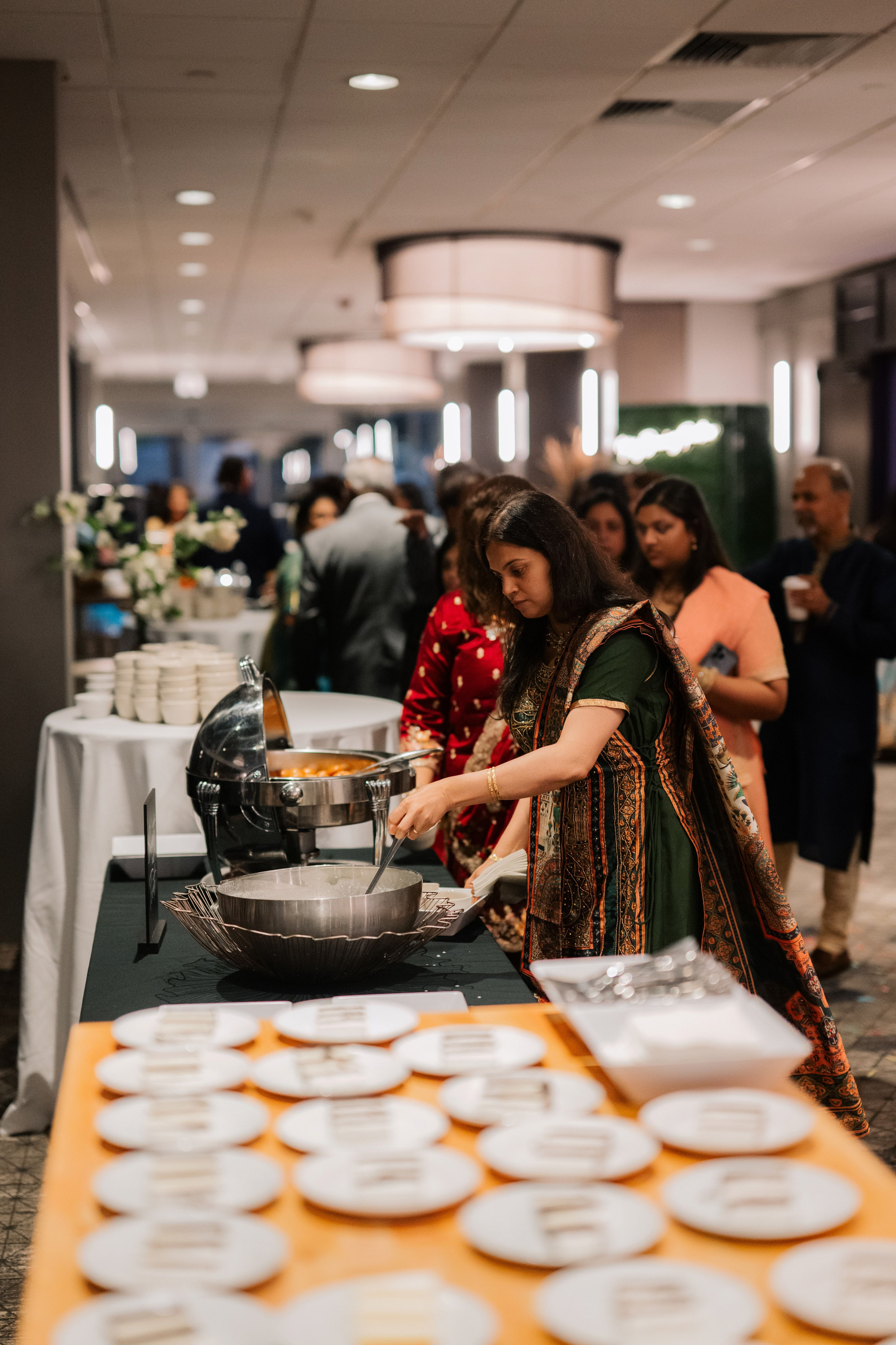 a woman preparing food in a large pan