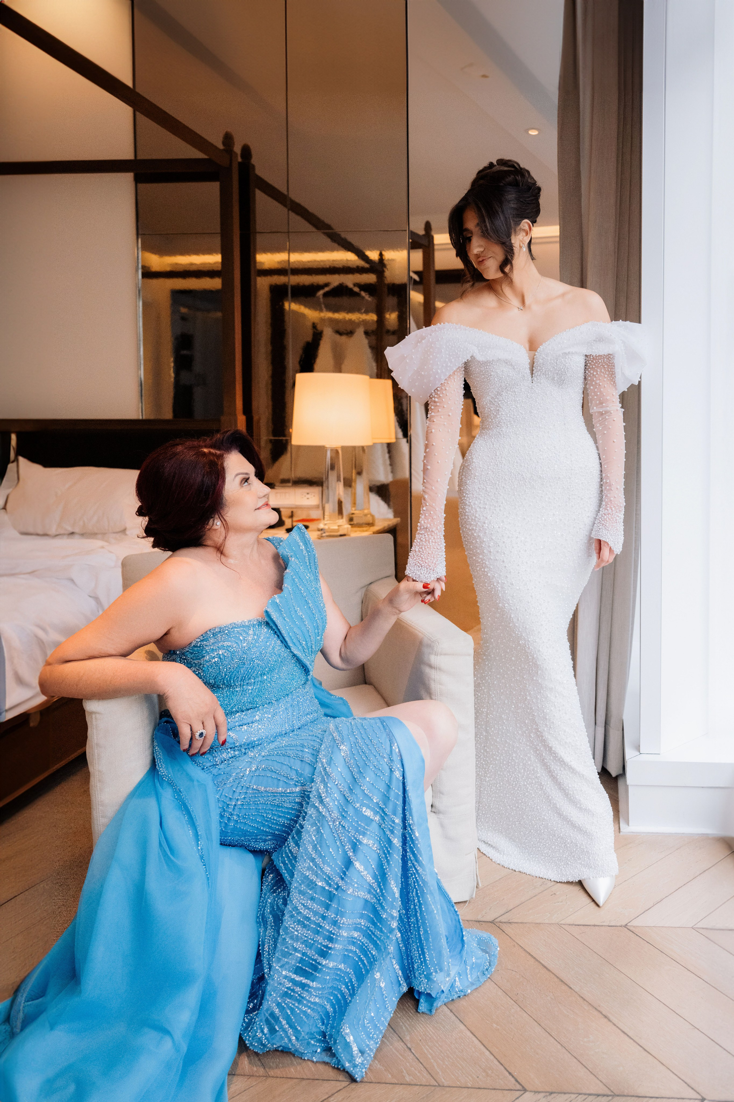 a woman in a blue dress is sitting on a couch