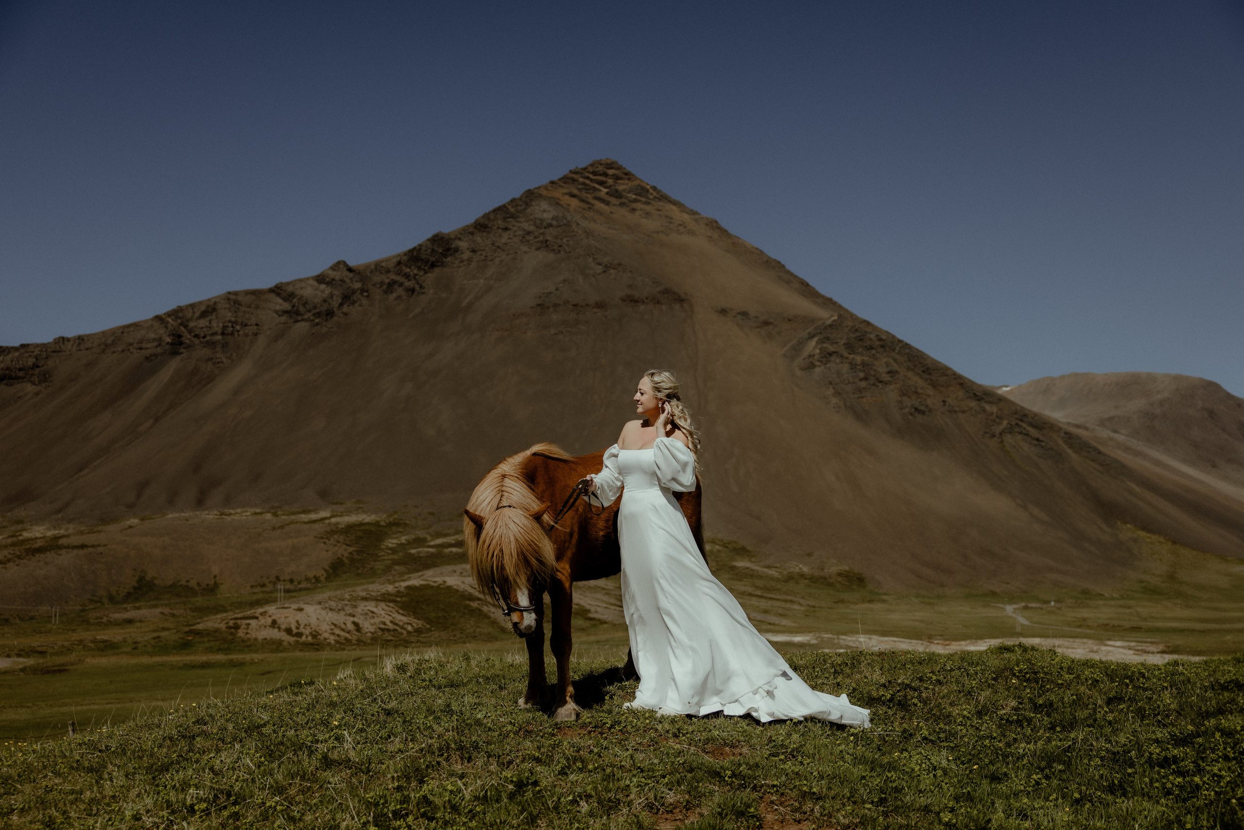 Iceland elopement at Budir with midnight sun wedding photos at black sand beach. Iceland elopement photographer & videographer