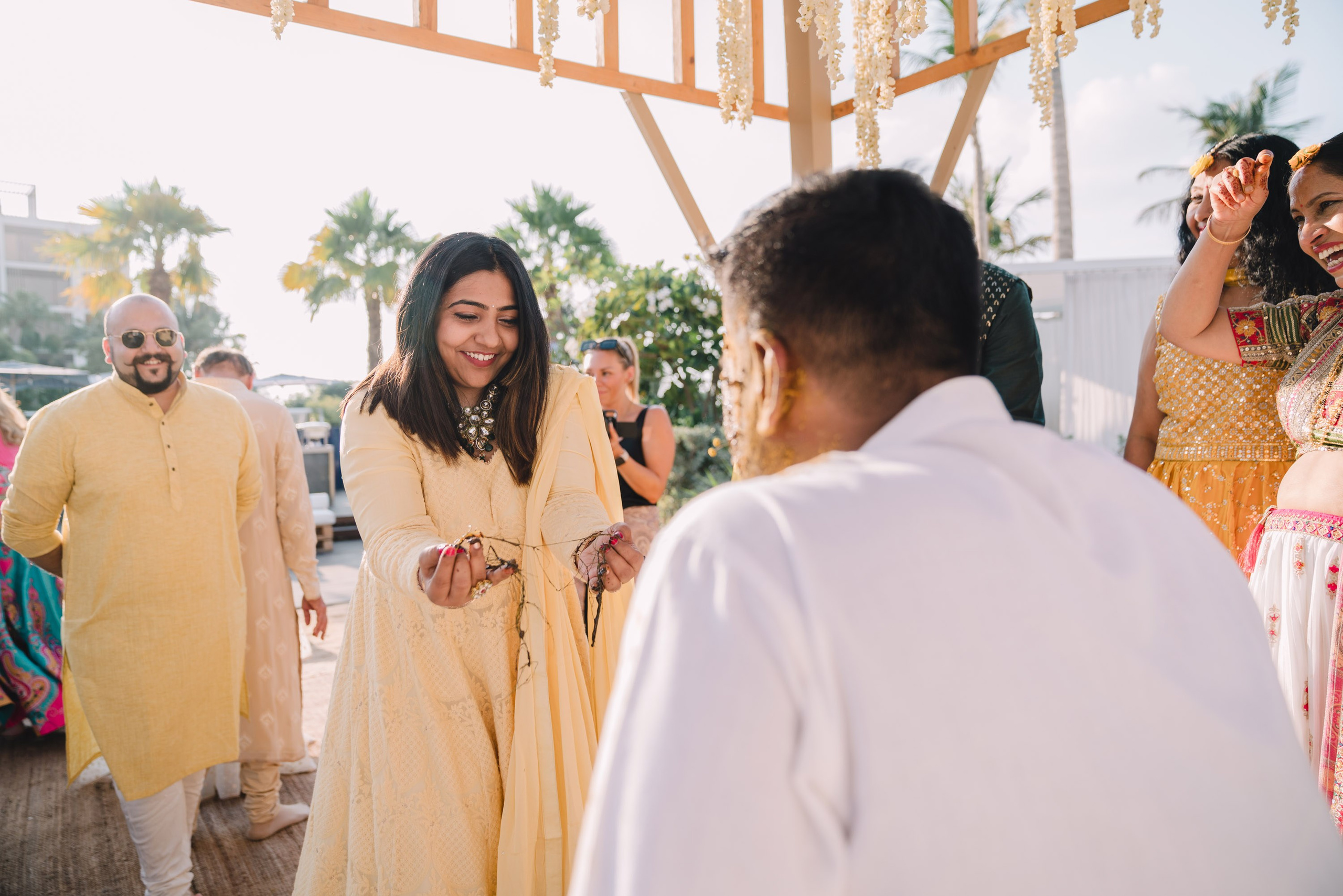 Lady is confused as her hands are dirty with oil and she has to proceed with turmeric ceremony