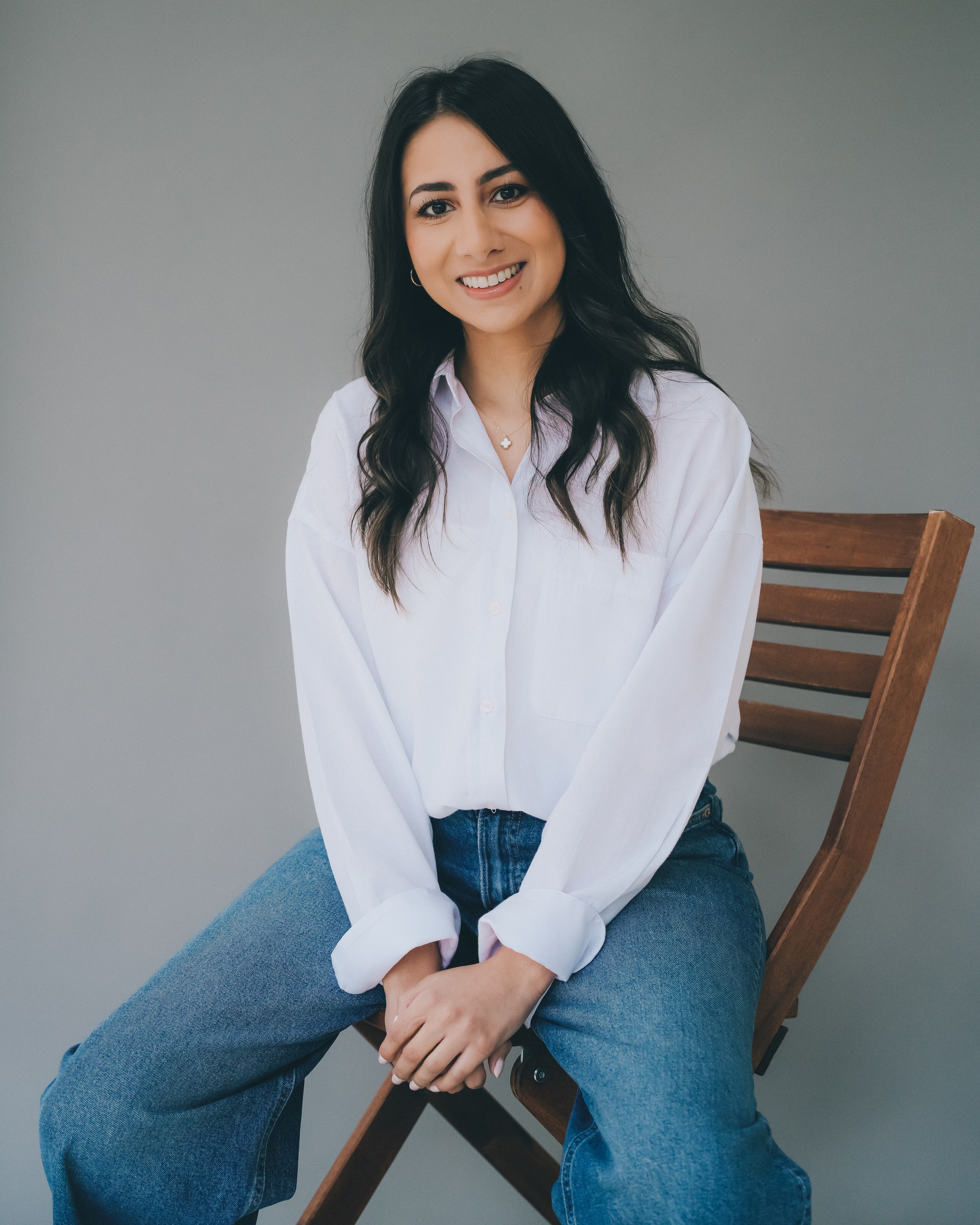 Relaxed lifestyle headshot of a woman seated in natural light, photographed in Solihull studio.