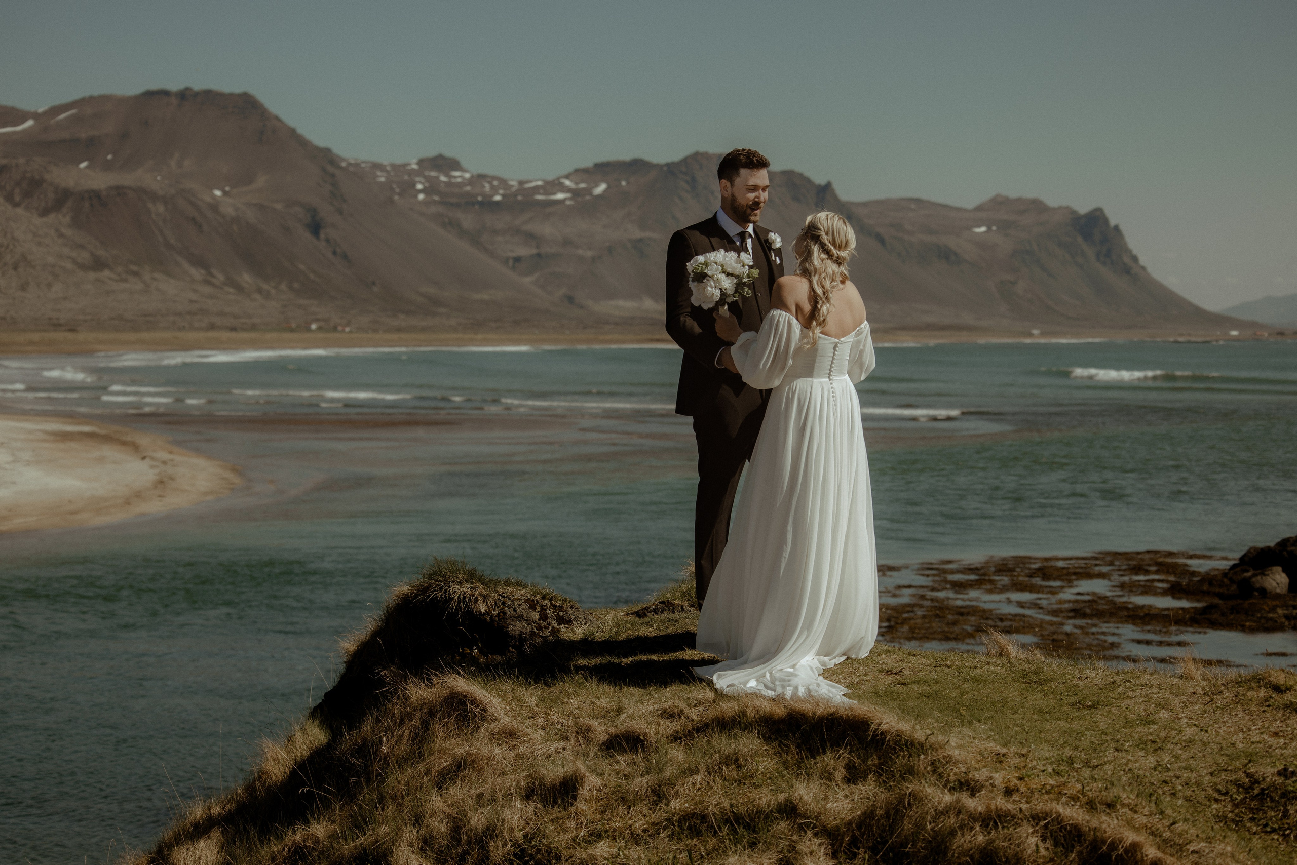 Iceland elopement at Budir with midnight sun wedding photos at black sand beach. Iceland elopement photographer & videographer