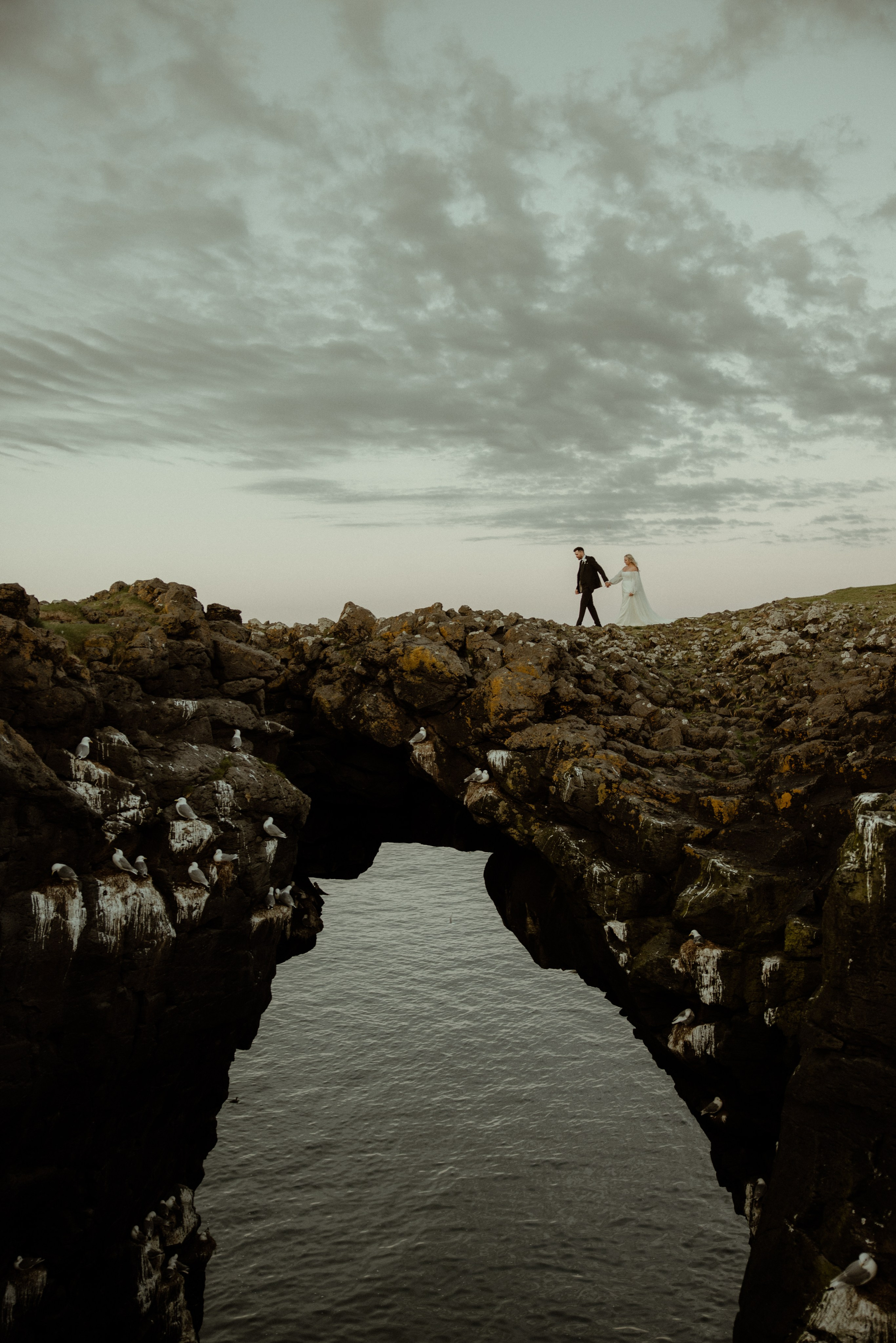 Iceland elopement at Budir with midnight sun wedding photos at black sand beach. Iceland elopement photographer & videographer