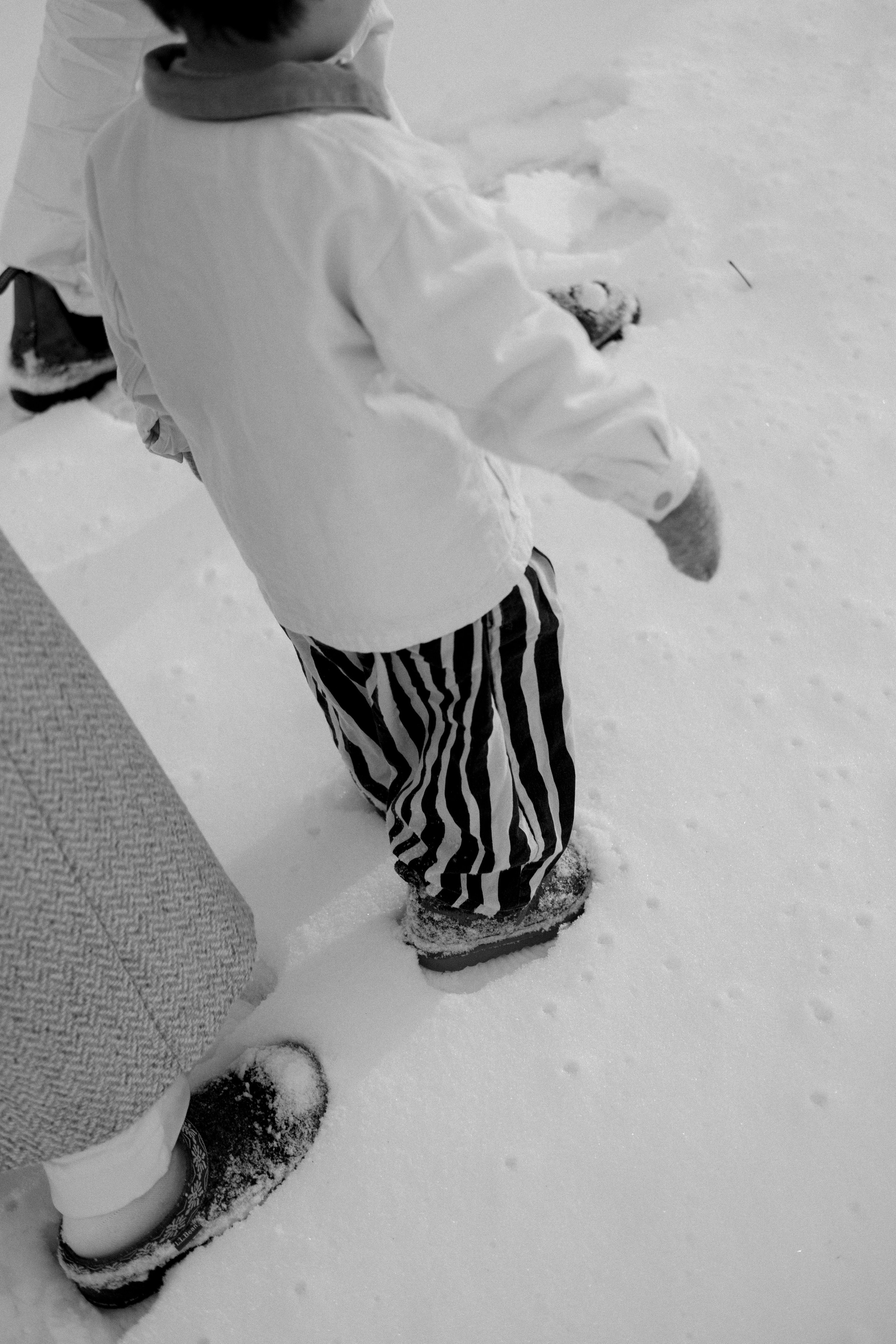 Artsistic photo of mom and her son walking in the snow in Richmond, VA