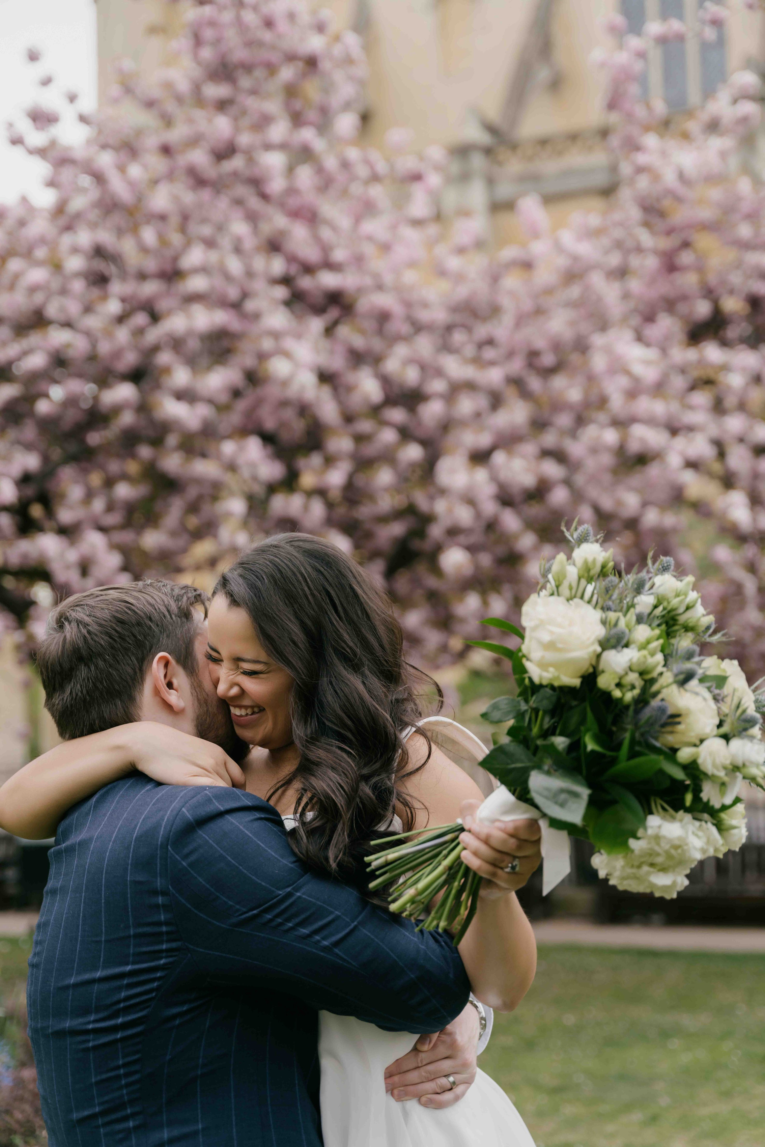 Spring wedding in Chelsea London with cherry blossom trees, romantic couple portraits in soft natural light