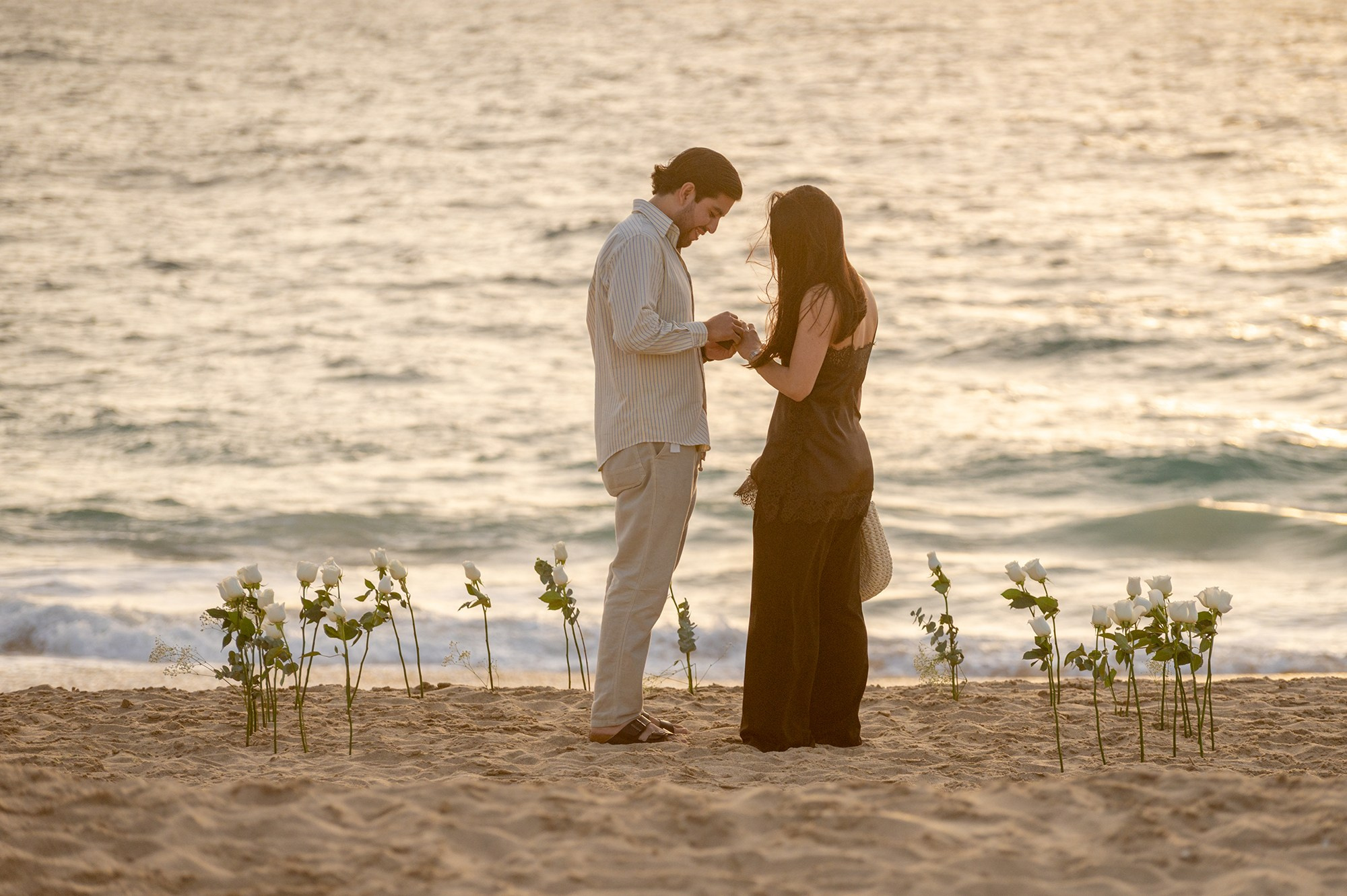 Surprise beach proposal photographed from a distance with telephoto lens in Todos Santos Baja California