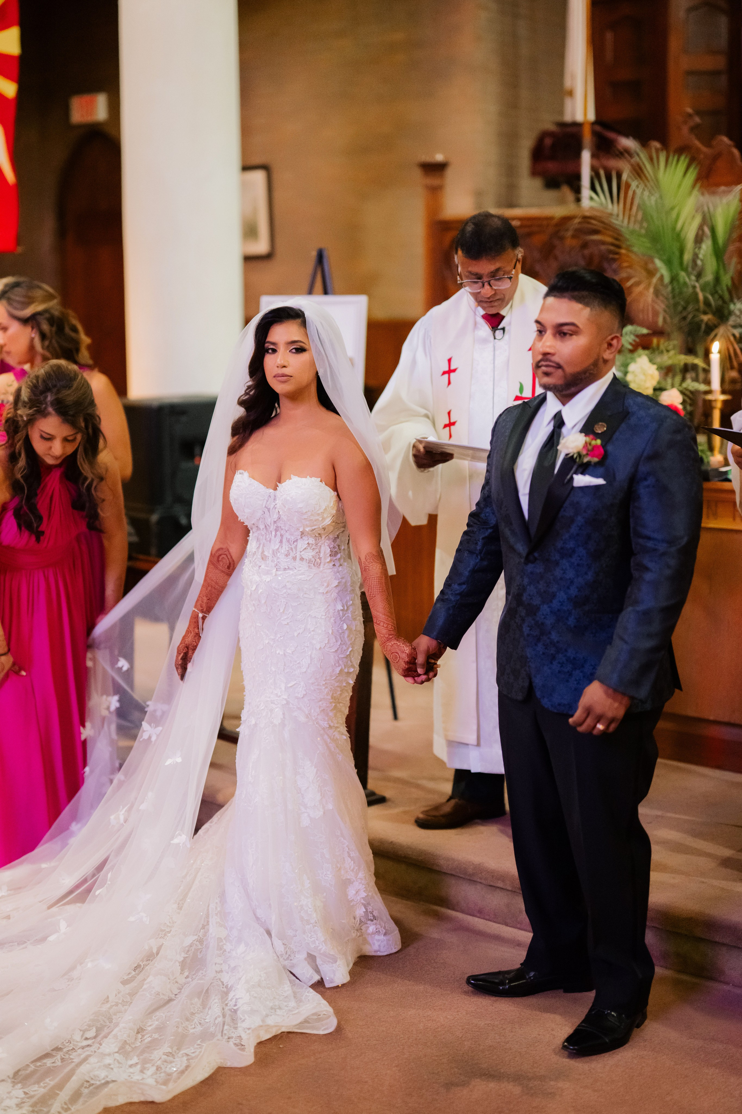 a bride and groom are walking down the aisle